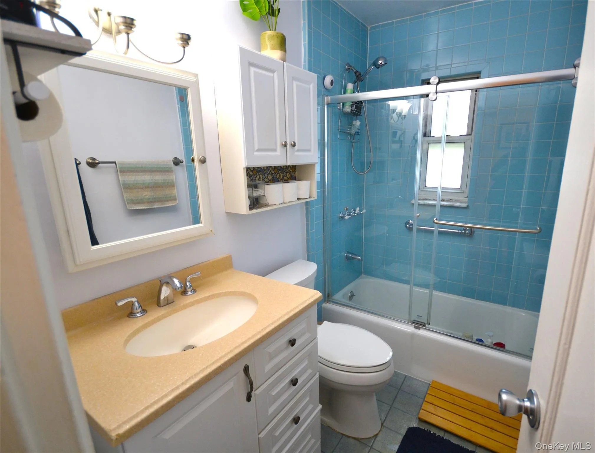 Bathroom featuring new glass shower doors. Tiled floor and new vanity. Bathroom featuring new glass shower doors. Tiled floor and new vanity.