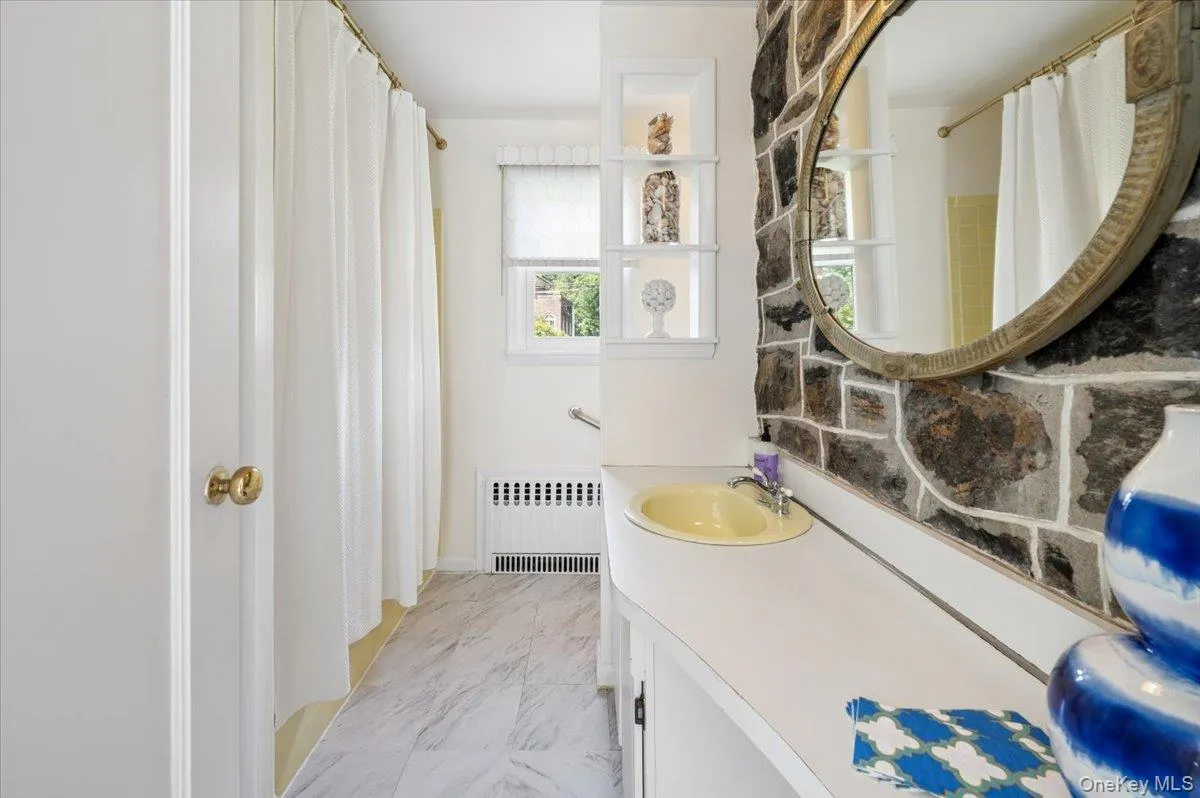 Full bath adjoining sunroom and storage closet. Full bath adjoining sunroom and storage closet.
