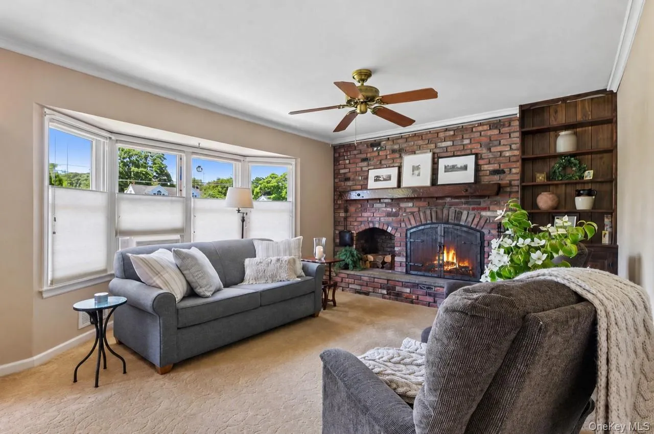 Living Rm w/fireplace, wood floors under carpeting. Living Rm w/fireplace, wood floors under carpeting.