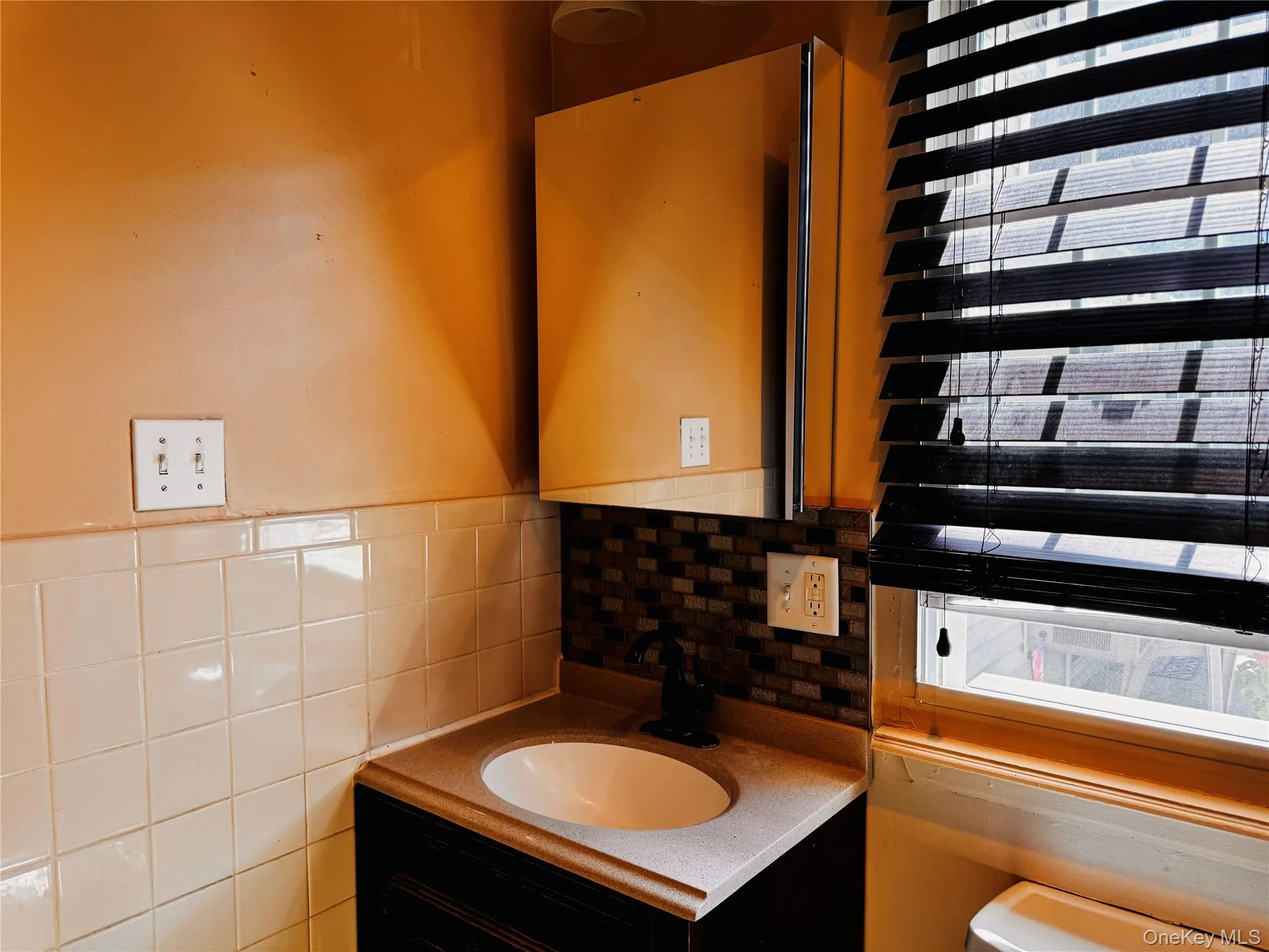 Full bathroom with vanity and mirror located in hallway. Full bathroom with vanity and mirror located in hallway.