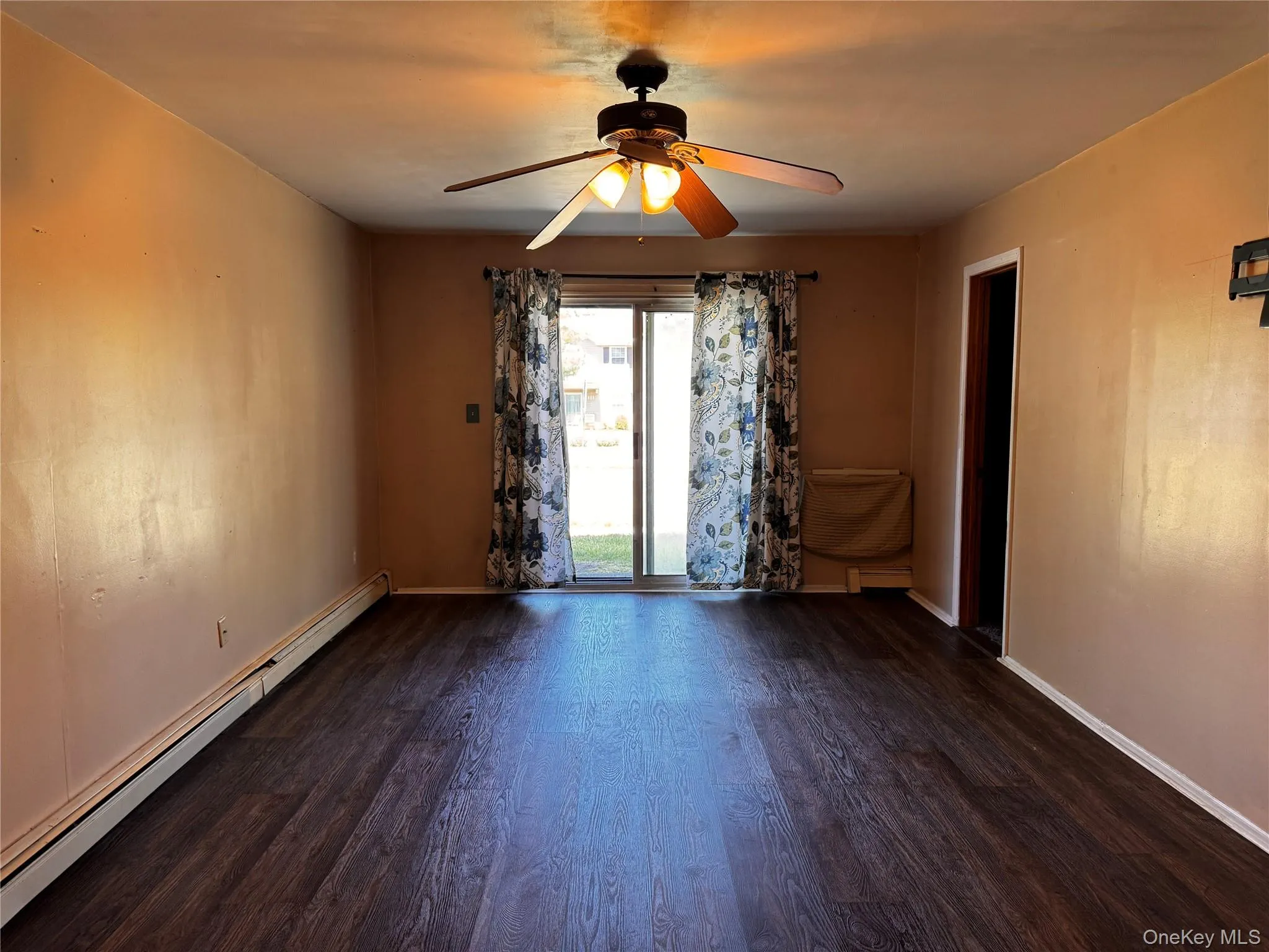 Large living room with sliding glass doors that lead to patio, vinyl plank flooring. Large living room with sliding glass doors that lead to patio, vinyl plank flooring.