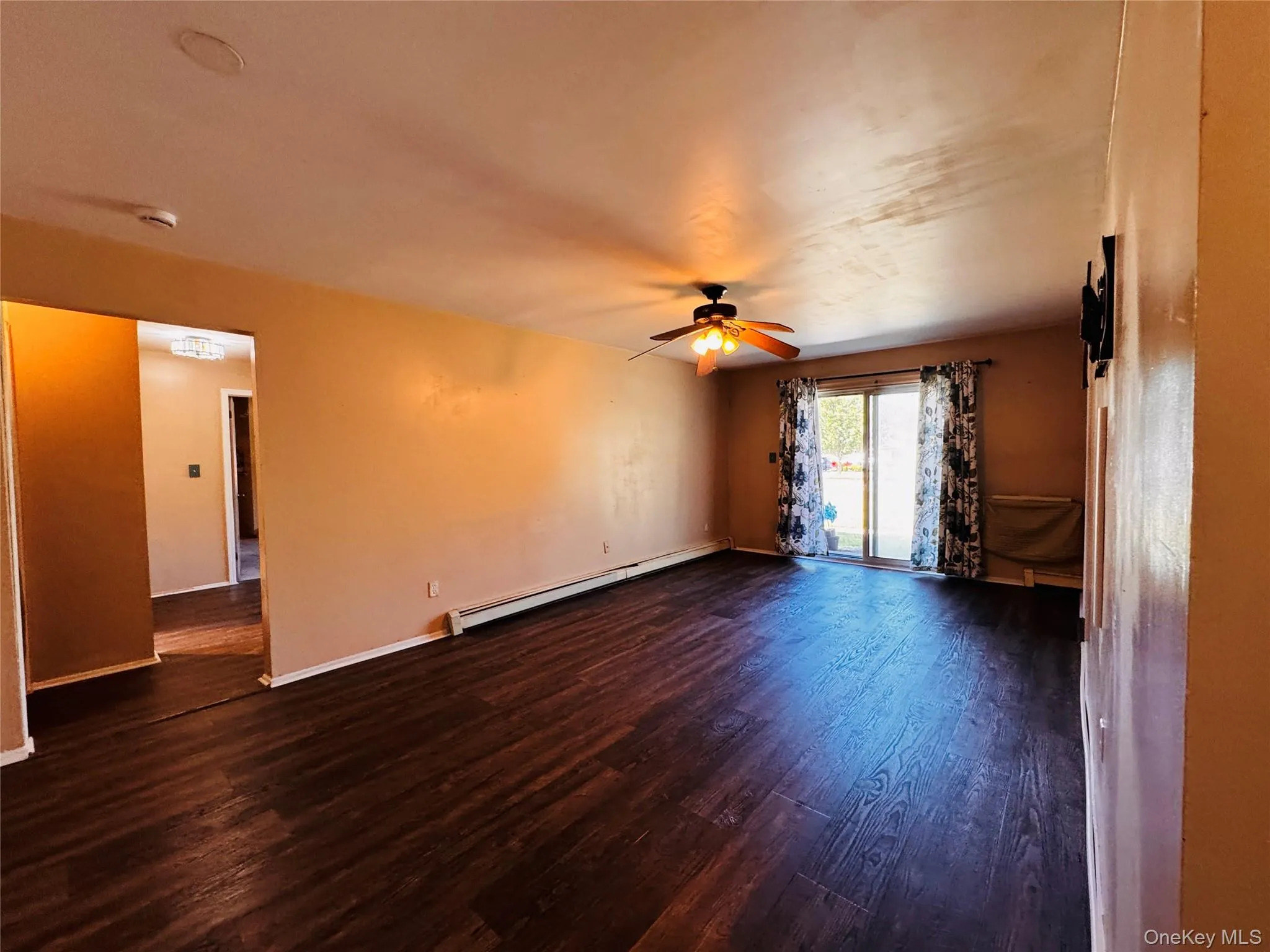 Large living room with sliding glass doors that lead to patio. Large living room with sliding glass doors that lead to patio.