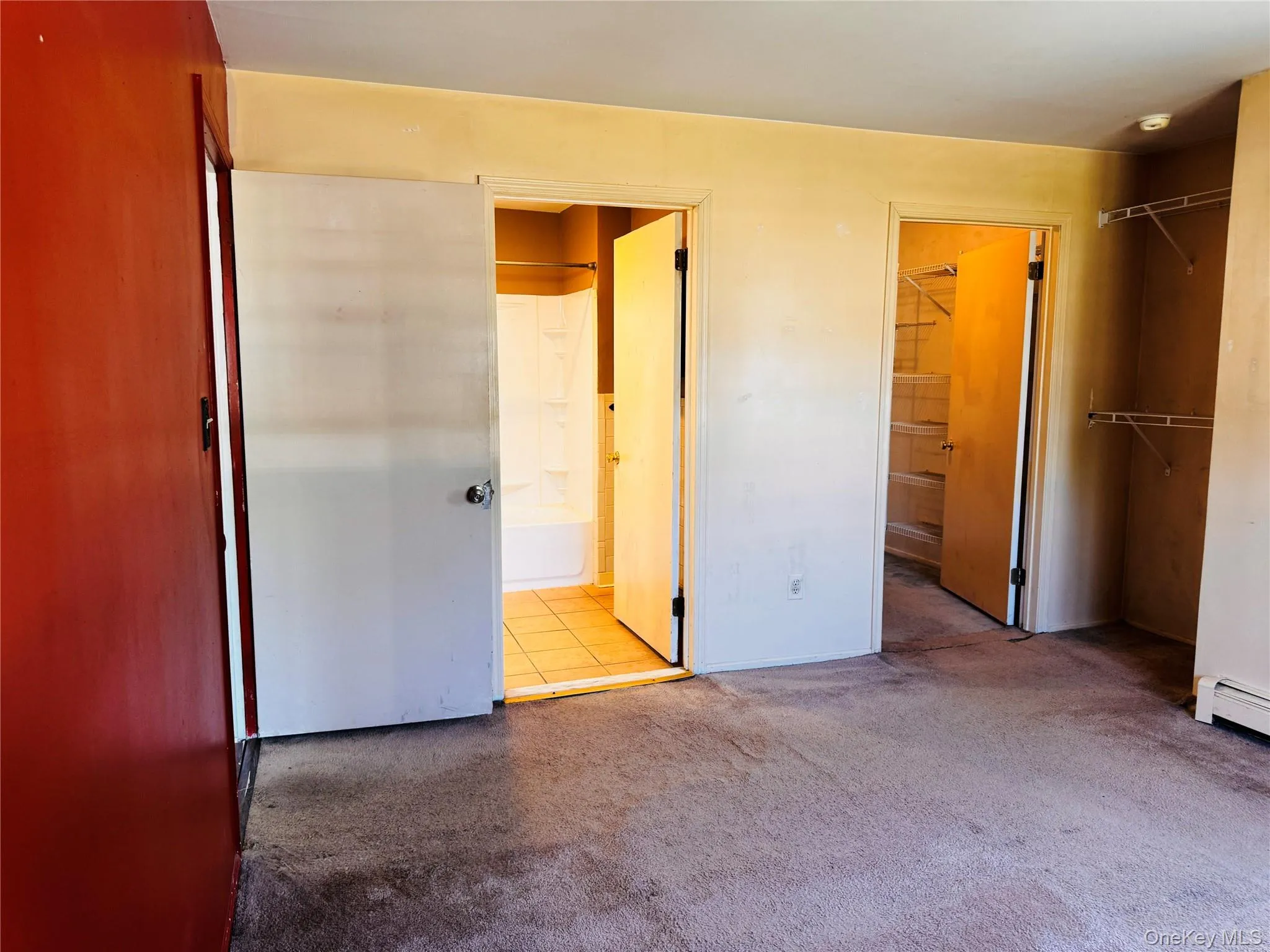 Primary bedroom view into primary bath and walk-in closet. Primary bedroom view into primary bath and walk-in closet.