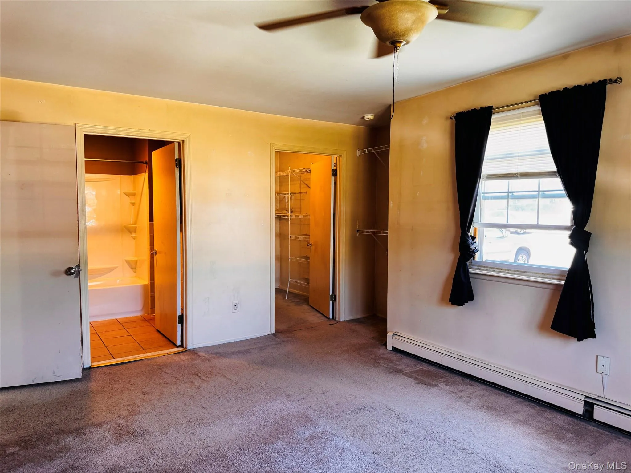 Primary Bedroom view into primary bath and walk-in closet. Primary Bedroom view into primary bath and walk-in closet.