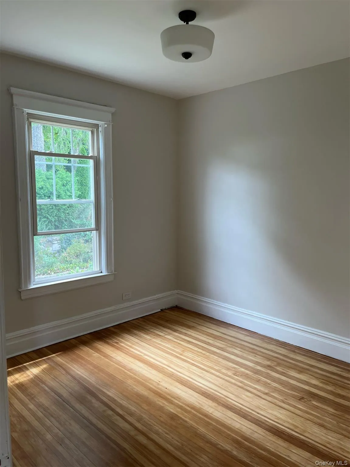 Bed room featuring healthy amount of natural light, and wood finished floors Bed room featuring healthy amount of natural light, and wood finished floors