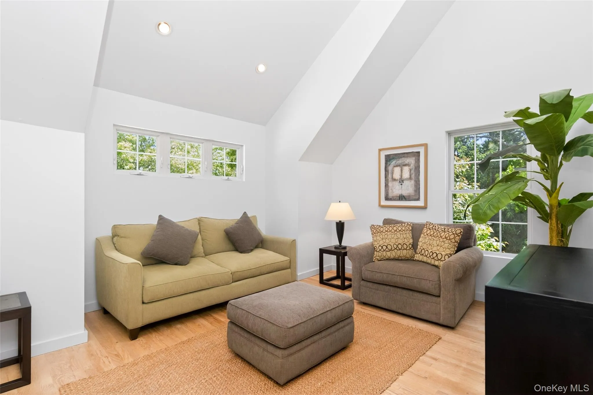 2nd floor Living Room featuring vaulted ceilings with recessed lighting, wood-finish flooring, and multiple windows 2nd floor Living Room featuring vaulted ceilings with recessed lighting, wood-finish flooring, and multiple windows