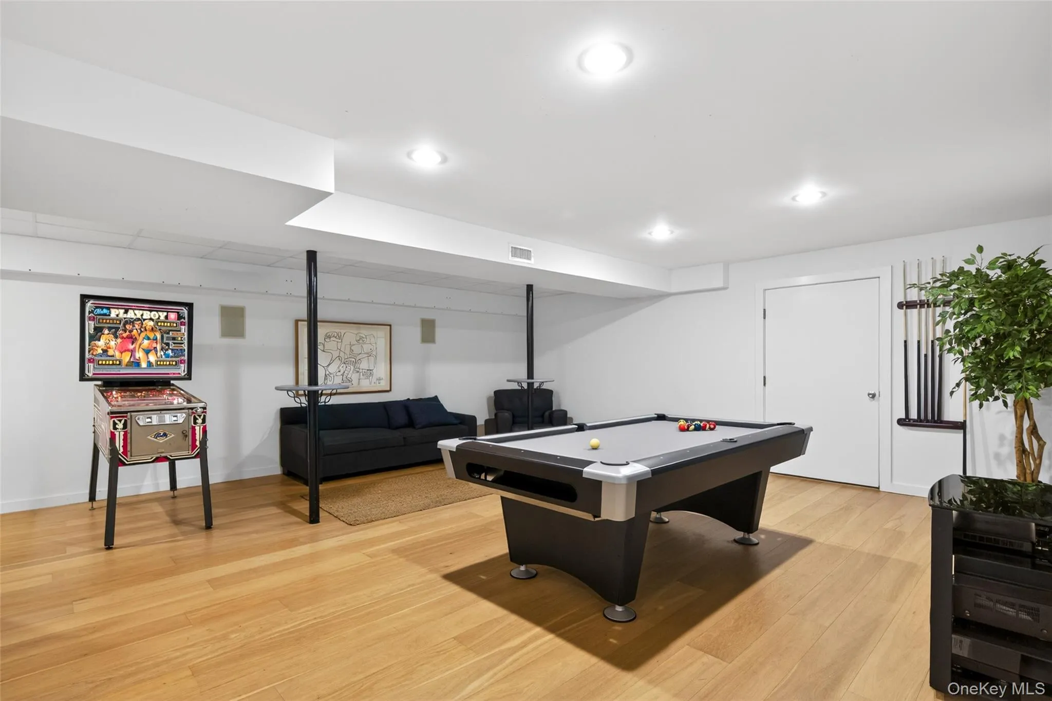 Spacious lower level featuring light wood-finish flooring, recessed lighting, white walls, and a white ceiling Spacious lower level featuring light wood-finish flooring, recessed lighting, white walls, and a white ceiling