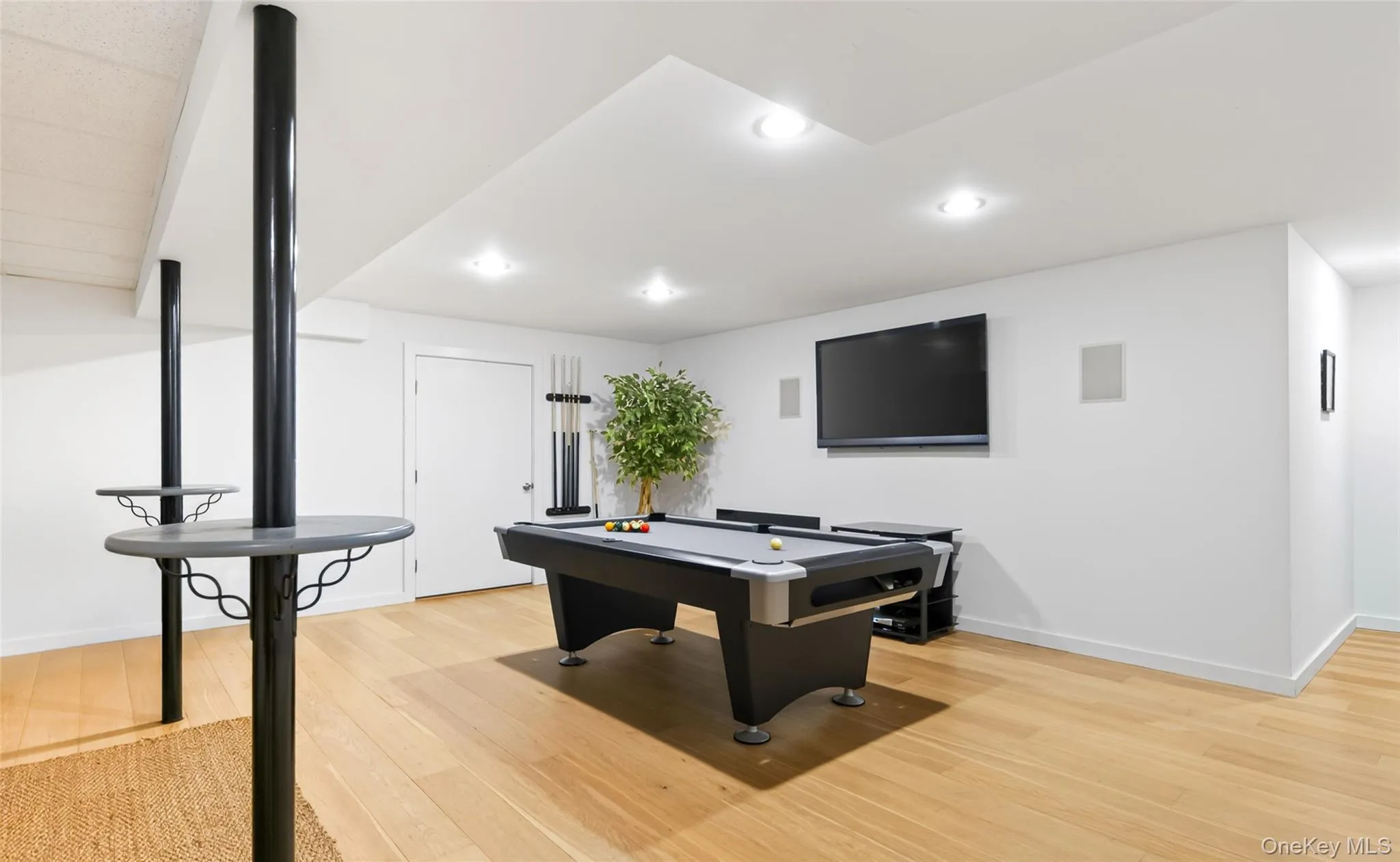 Finished lower level featuring light wood-finish flooring and recessed lighting Finished lower level featuring light wood-finish flooring and recessed lighting