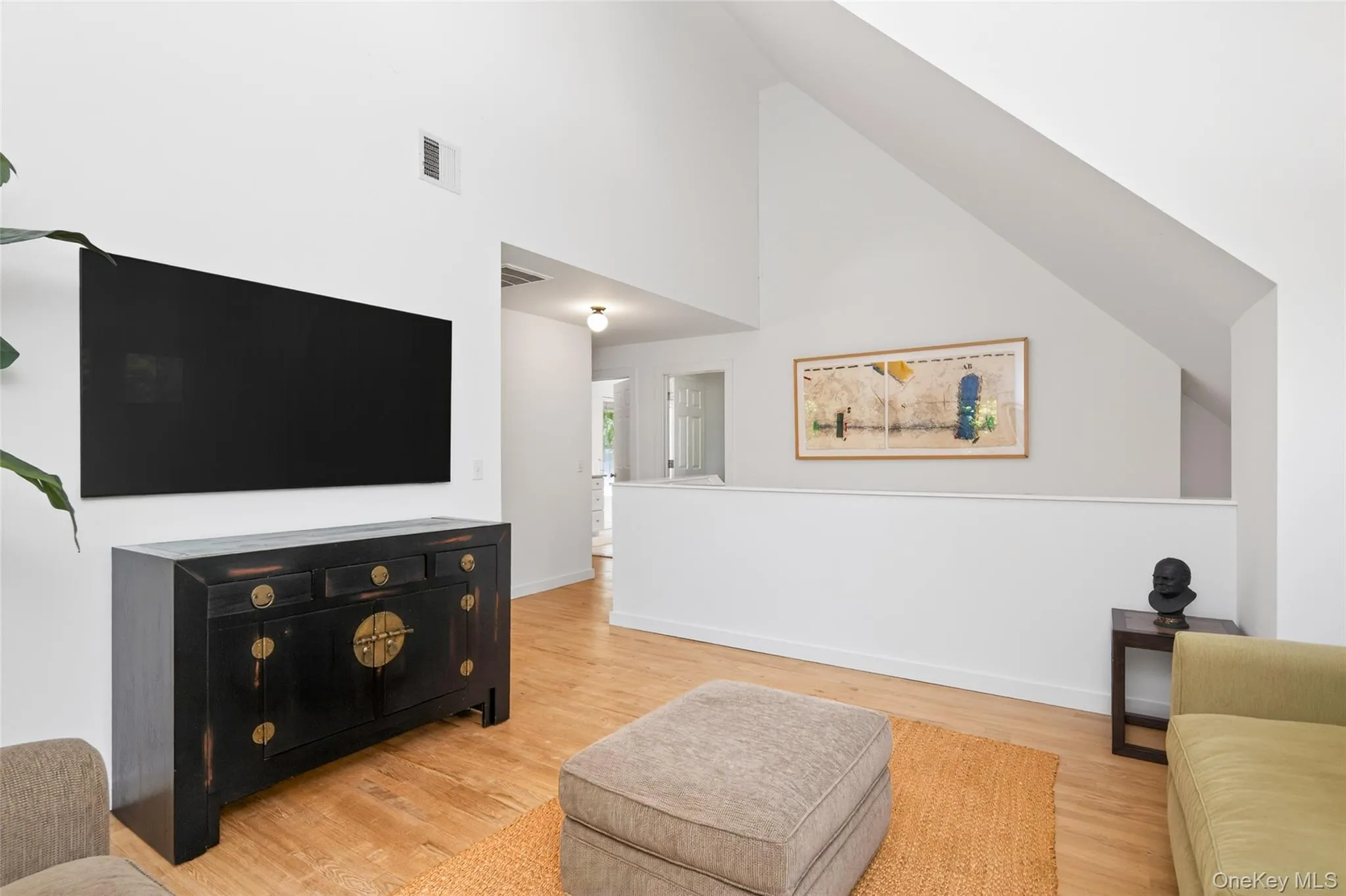 Vaulted ceilings and light wood-finish flooring create an open and airy atmosphere Vaulted ceilings and light wood-finish flooring create an open and airy atmosphere