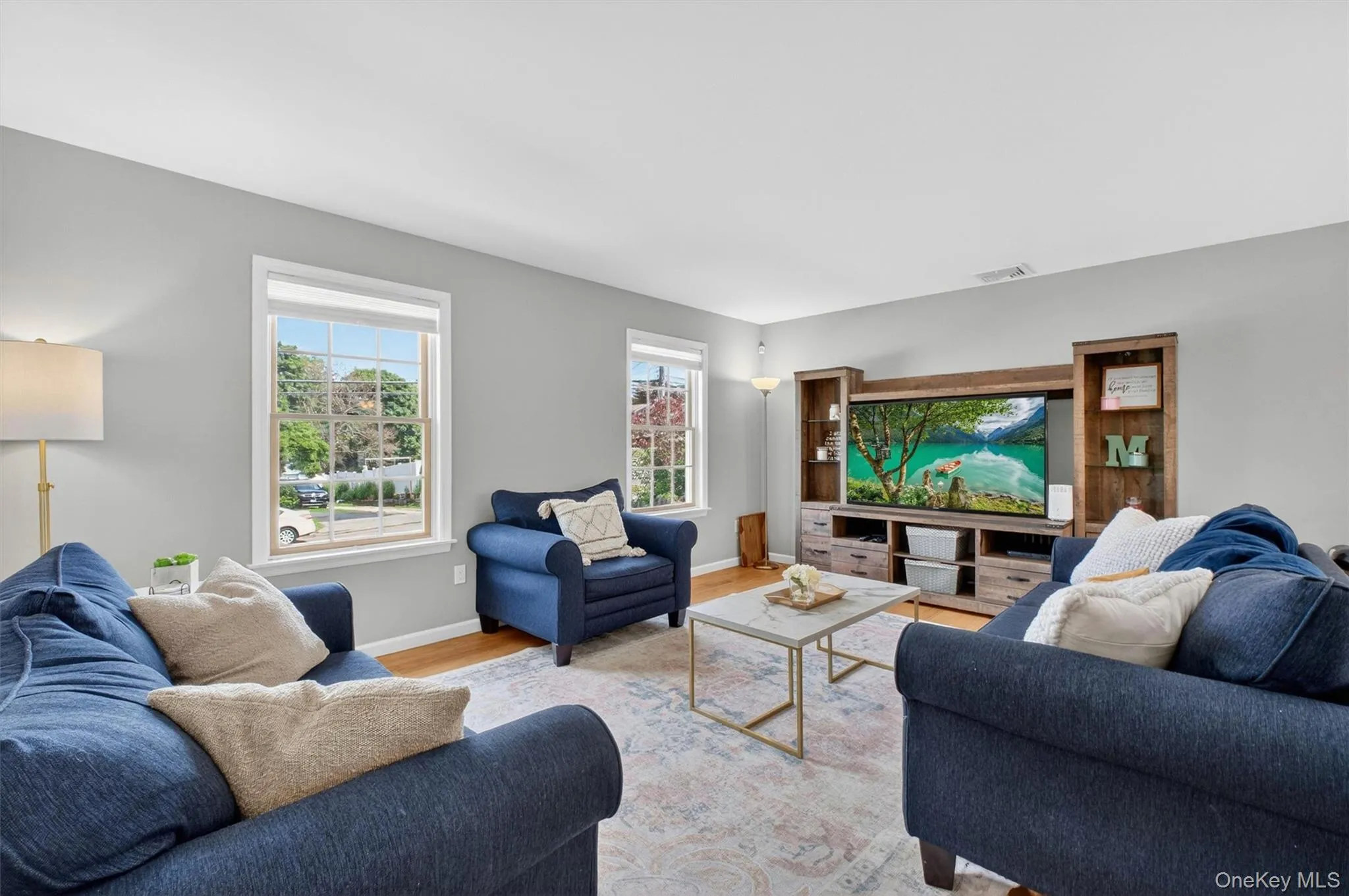 Sun filled living room. The main level is accented with hardwood flooring. Sun filled living room. The main level is accented with hardwood flooring.