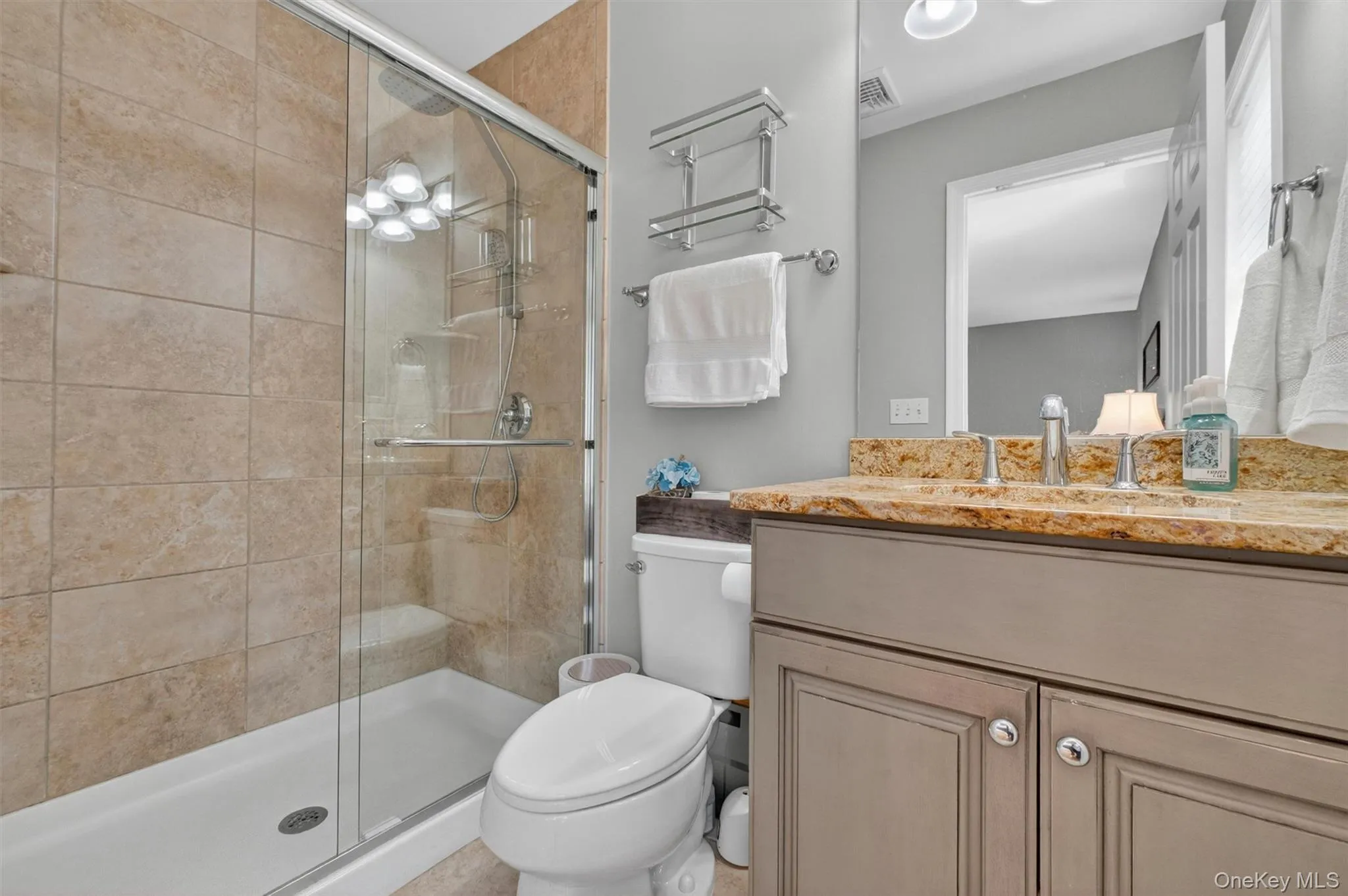 The primary bathroom with a shower and sliding glass doors. The primary bathroom with a shower and sliding glass doors.