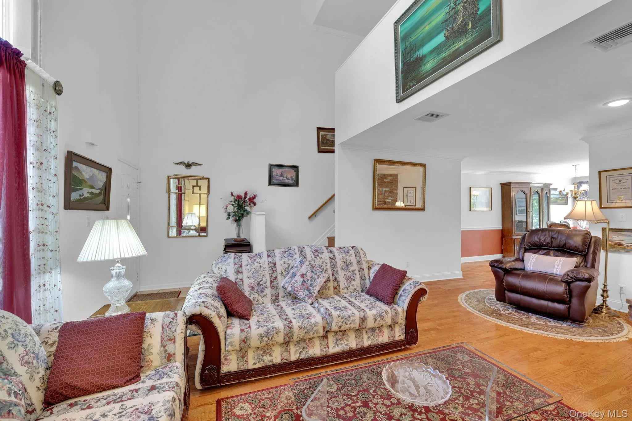 Living room with large windows and high ceilings. Living room with large windows and high ceilings.