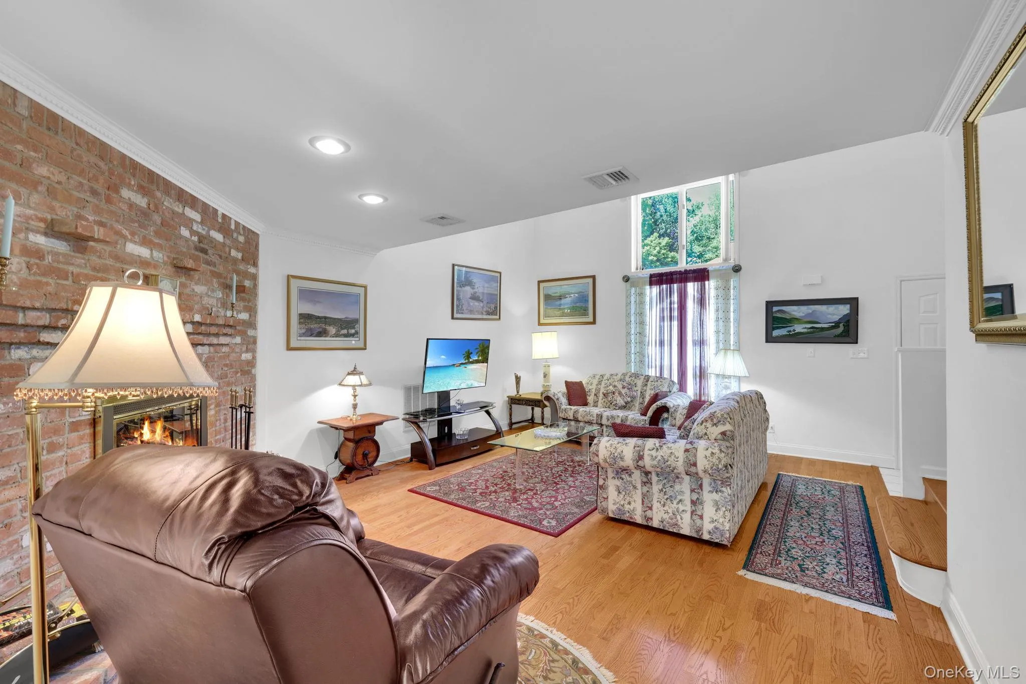 Living room with large windows, letting in lots of natural light. Living room with large windows, letting in lots of natural light.