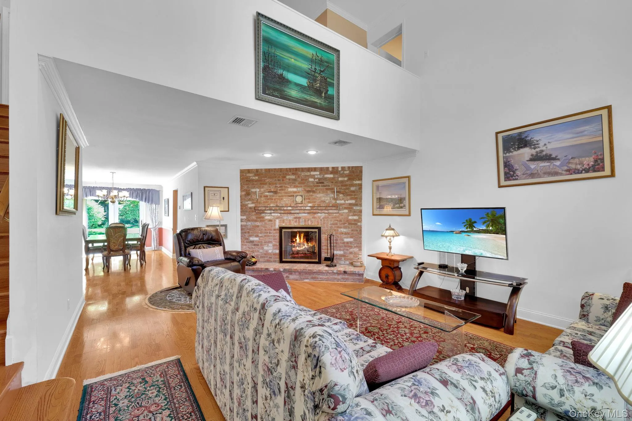 Entryway into living room with high ceilings and fireplace. Entryway into living room with high ceilings and fireplace.