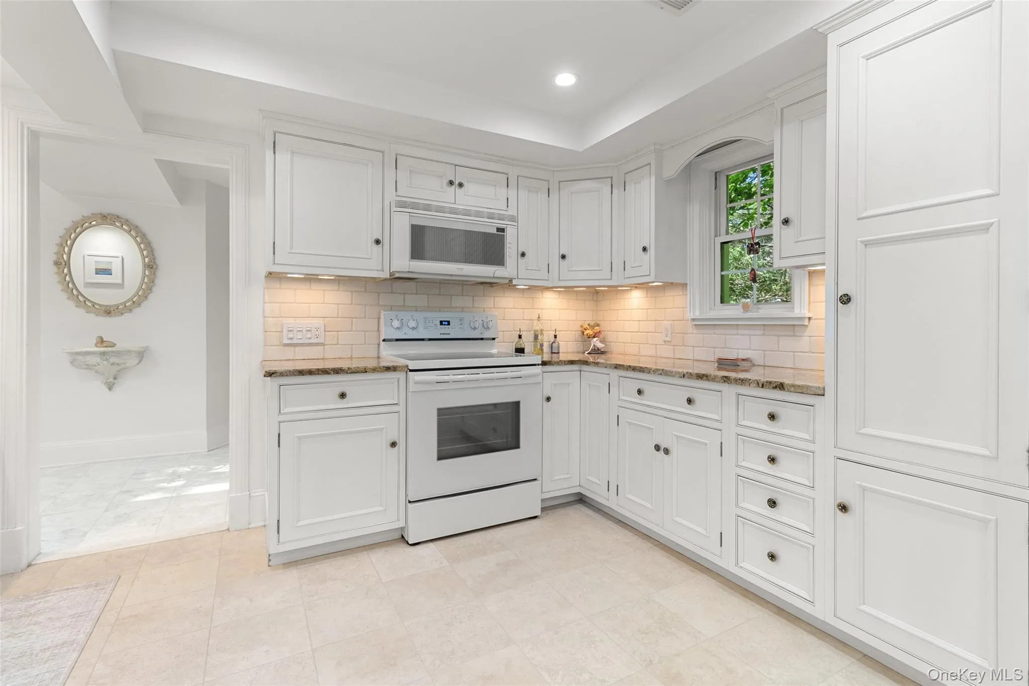 Modern kitchen, high end cabinetry, granite cabinets, stone splash back, travertine floors Modern kitchen, high end cabinetry, granite cabinets, stone splash back, travertine floors