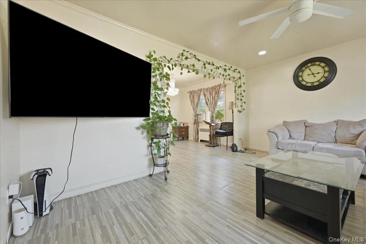 Living area featuring wood-finish flooring, recessed lighting, and a ceiling fan Living area featuring wood-finish flooring, recessed lighting, and a ceiling fan