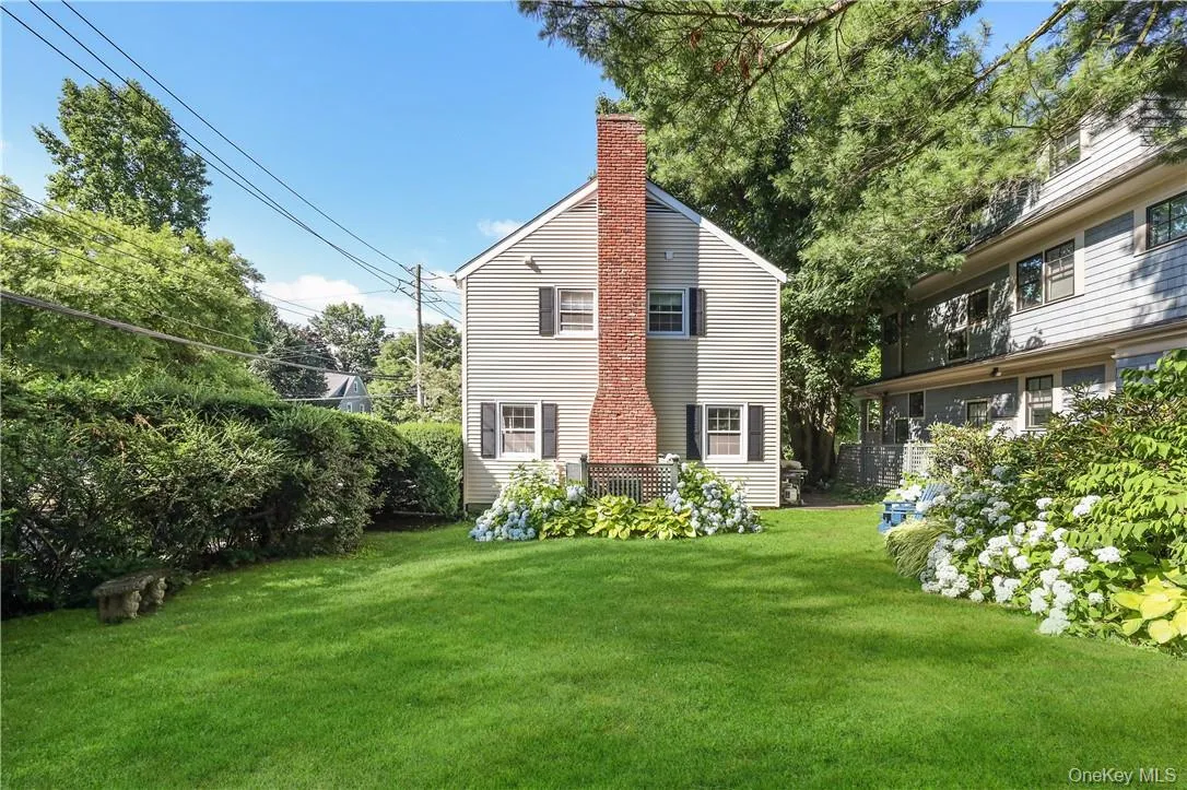 Rear view of house featuring a lawn Rear view of house featuring a lawn