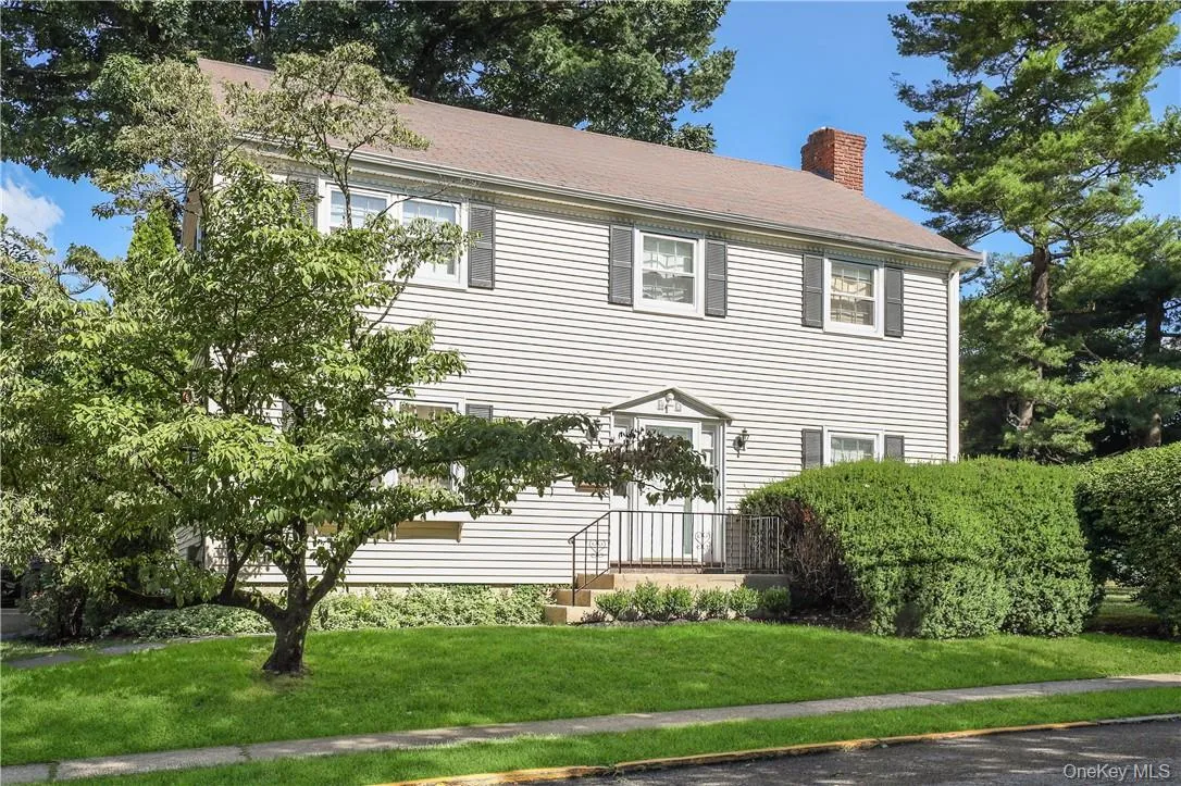 Colonial home featuring a front lawn Colonial home featuring a front lawn