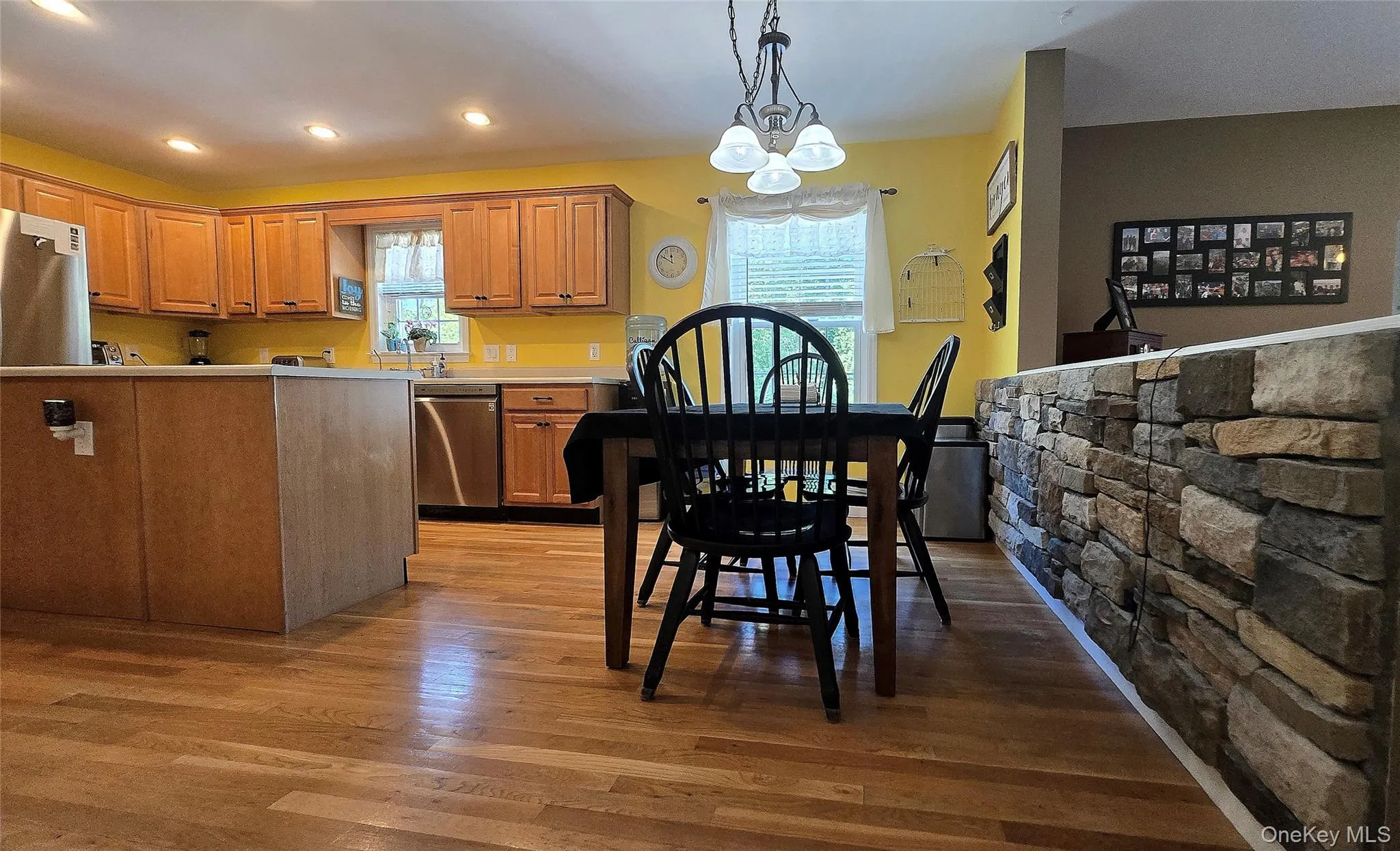 Breakfast nook with center island and stone half wall separates the kitchen from the family room. Breakfast nook with center island and stone half wall separates the kitchen from the family room.