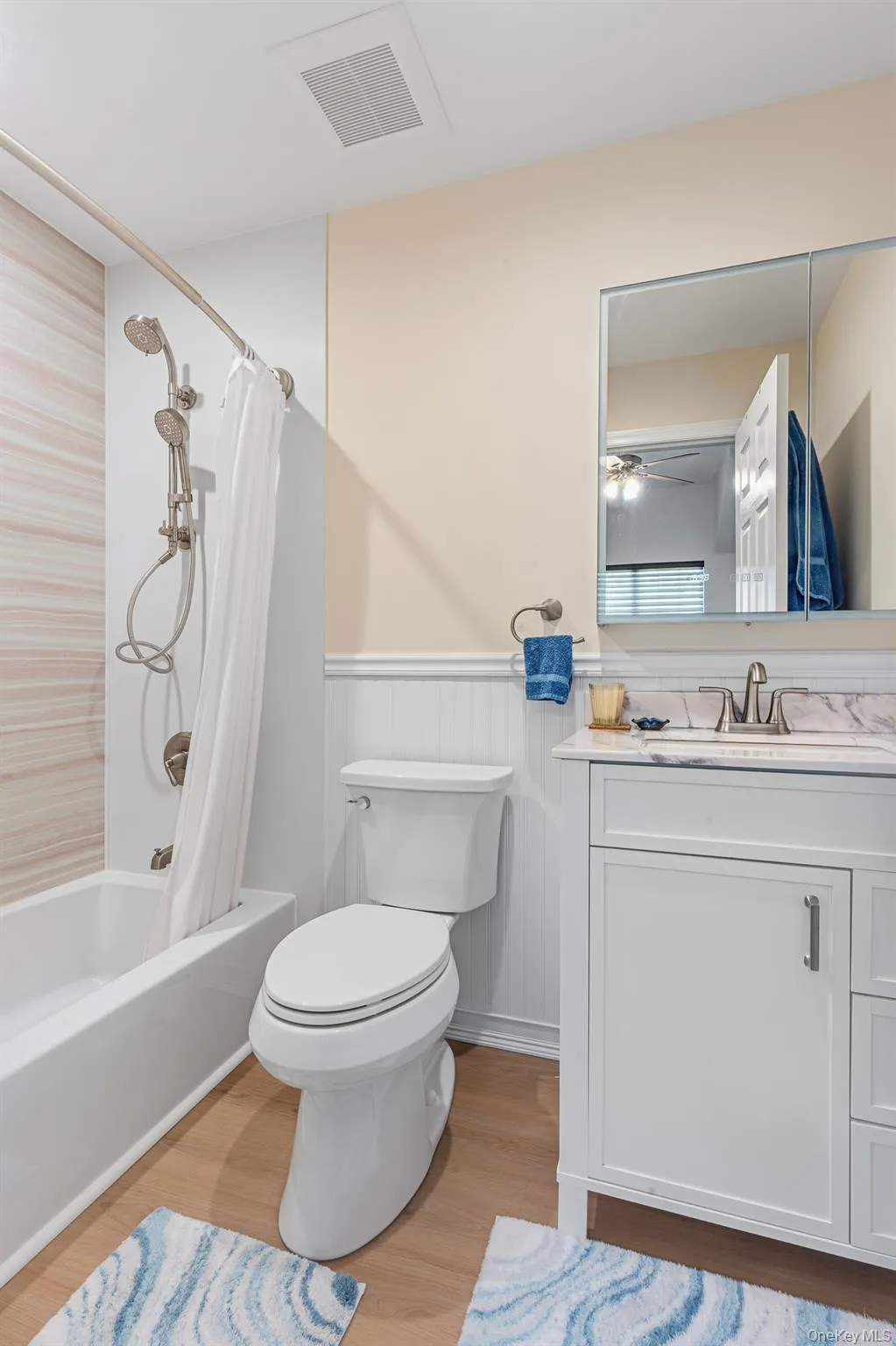 Another View Of The Beautifully Appointed, Brand New Guest Bathroom Offering A Full Bathtub With Stunning Accent Wall, Wainscoted Walls, Plank Tiled Floors, Stone Topped Vanity, Illuminated Mirror, Recessed Lighting & All Upgraded Fixtures. Another View Of The Beautifully Appointed, Brand New Guest Bathroom Offering A Full Bathtub With Stunning Accent Wall, Wainscoted Walls, Plank Tiled Floors, Stone Topped Vanity, Illuminated Mirror, Recessed Lighting & All Upgraded Fixtures.