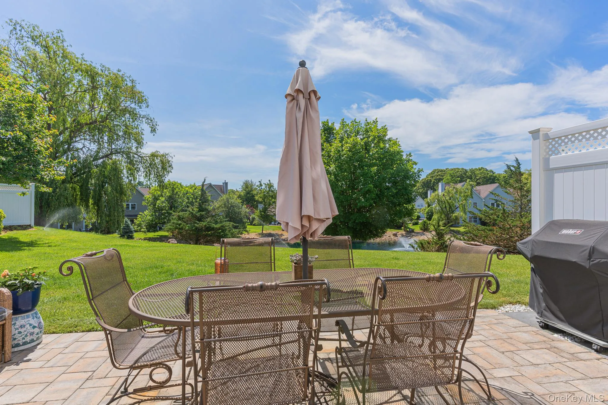 The Back Of The Townhome Offers A Three Year Old Expansive Paver Patio With PVC Privacy Fencing On The Sides & A Spectacular Location With Unobstructed Views Of The Lake, Fountain And Beautiful Open Lawns, Grasses & Community Open Spaces! The Back Of The Townhome Offers A Three Year Old Expansive Paver Patio With PVC Privacy Fencing On The Sides & A Spectacular Location With Unobstructed Views Of The Lake, Fountain And Beautiful Open Lawns, Grasses & Community Open Spaces!