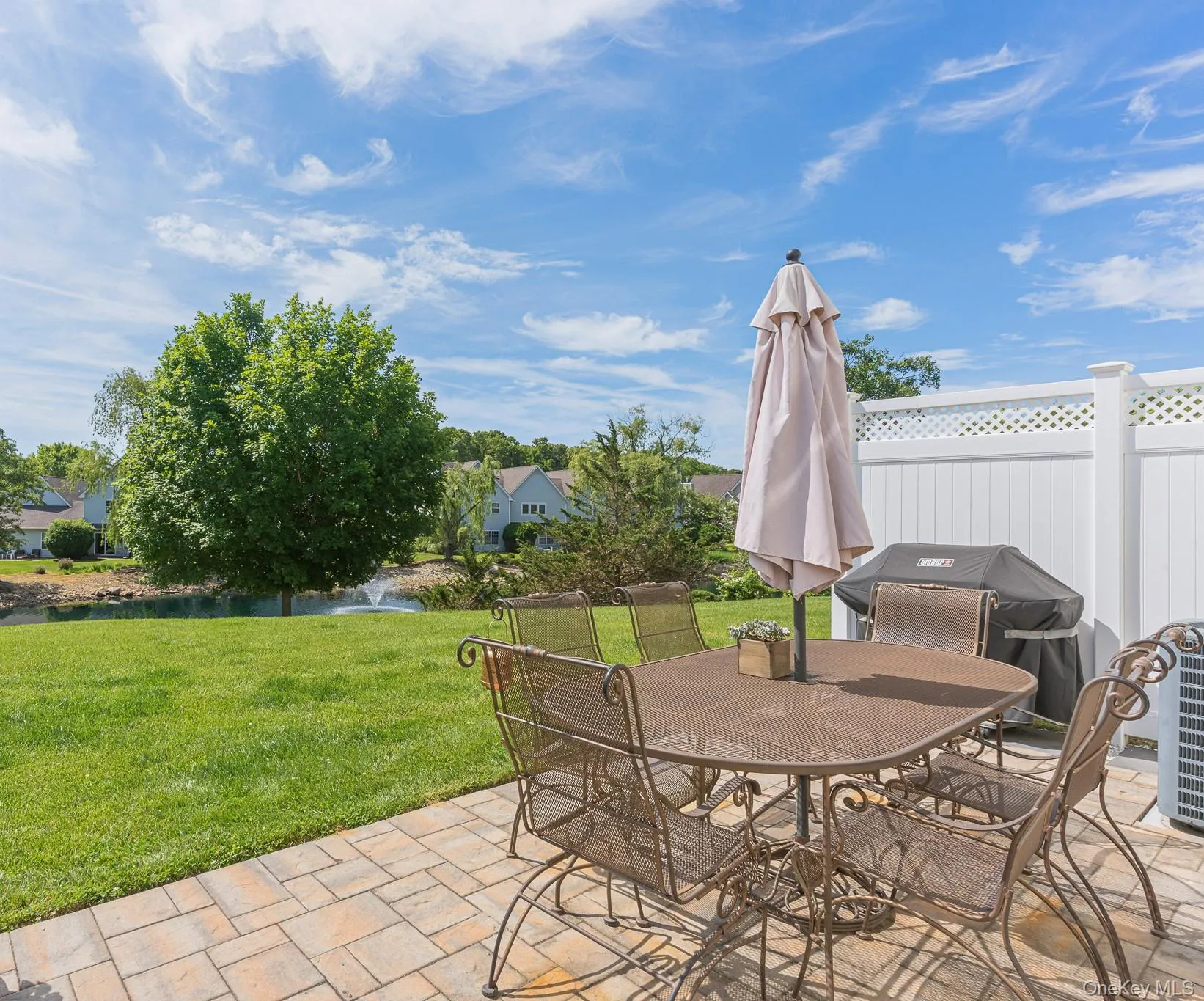 The Back Of The Townhome Offers A Three Year Old Expansive Paver Patio With PVC Privacy Fencing On The Sides & A Spectacular Location With Unobstructed Views Of The Lake, Fountain And Beautiful Open Lawns, Grasses & Community Open Spaces! The Back Of The Townhome Offers A Three Year Old Expansive Paver Patio With PVC Privacy Fencing On The Sides & A Spectacular Location With Unobstructed Views Of The Lake, Fountain And Beautiful Open Lawns, Grasses & Community Open Spaces!