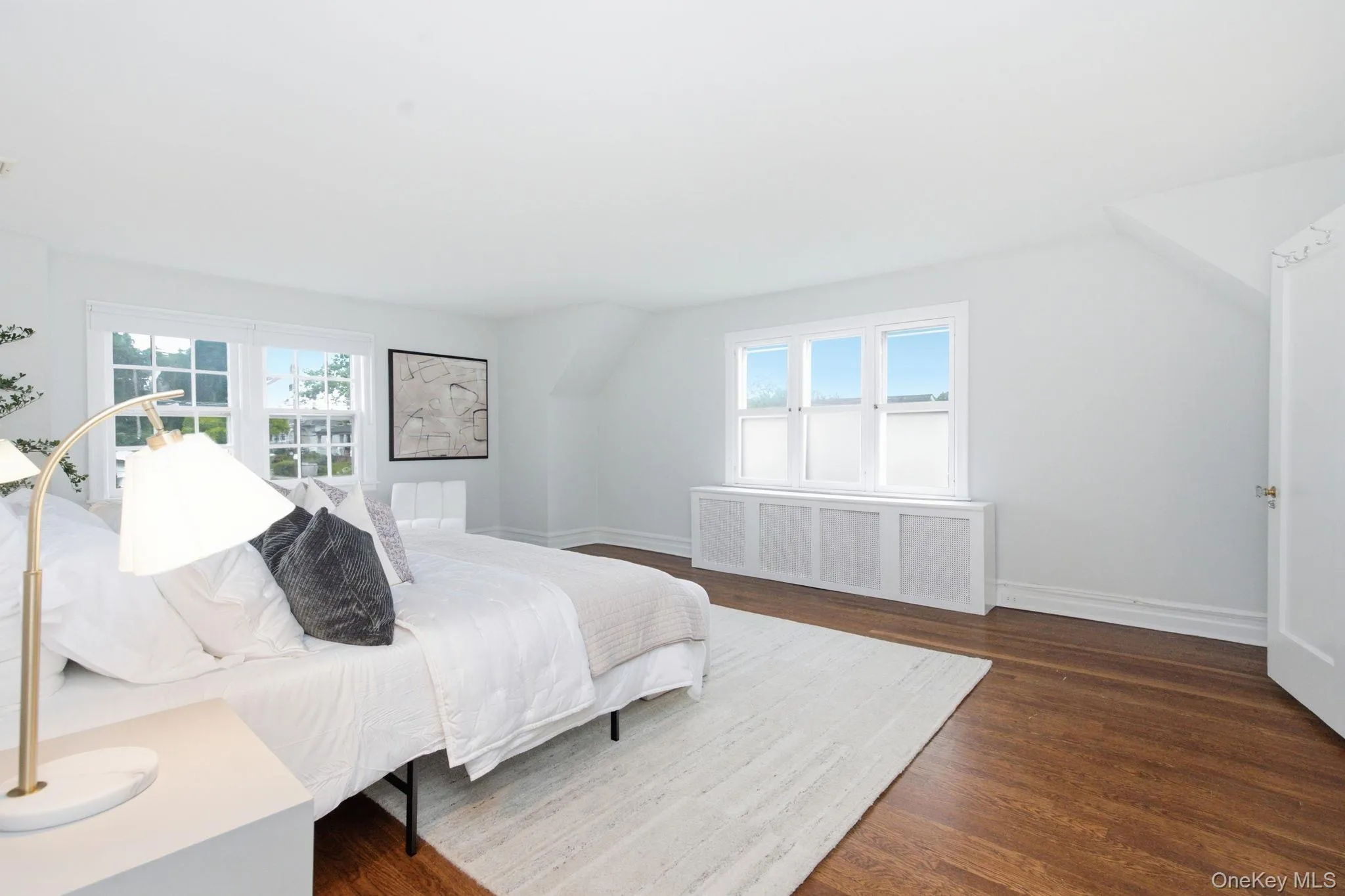 The primary bedroom lives large, with a walk-in closet and marble ensuite bath completing the suite. The primary bedroom lives large, with a walk-in closet and marble ensuite bath completing the suite.