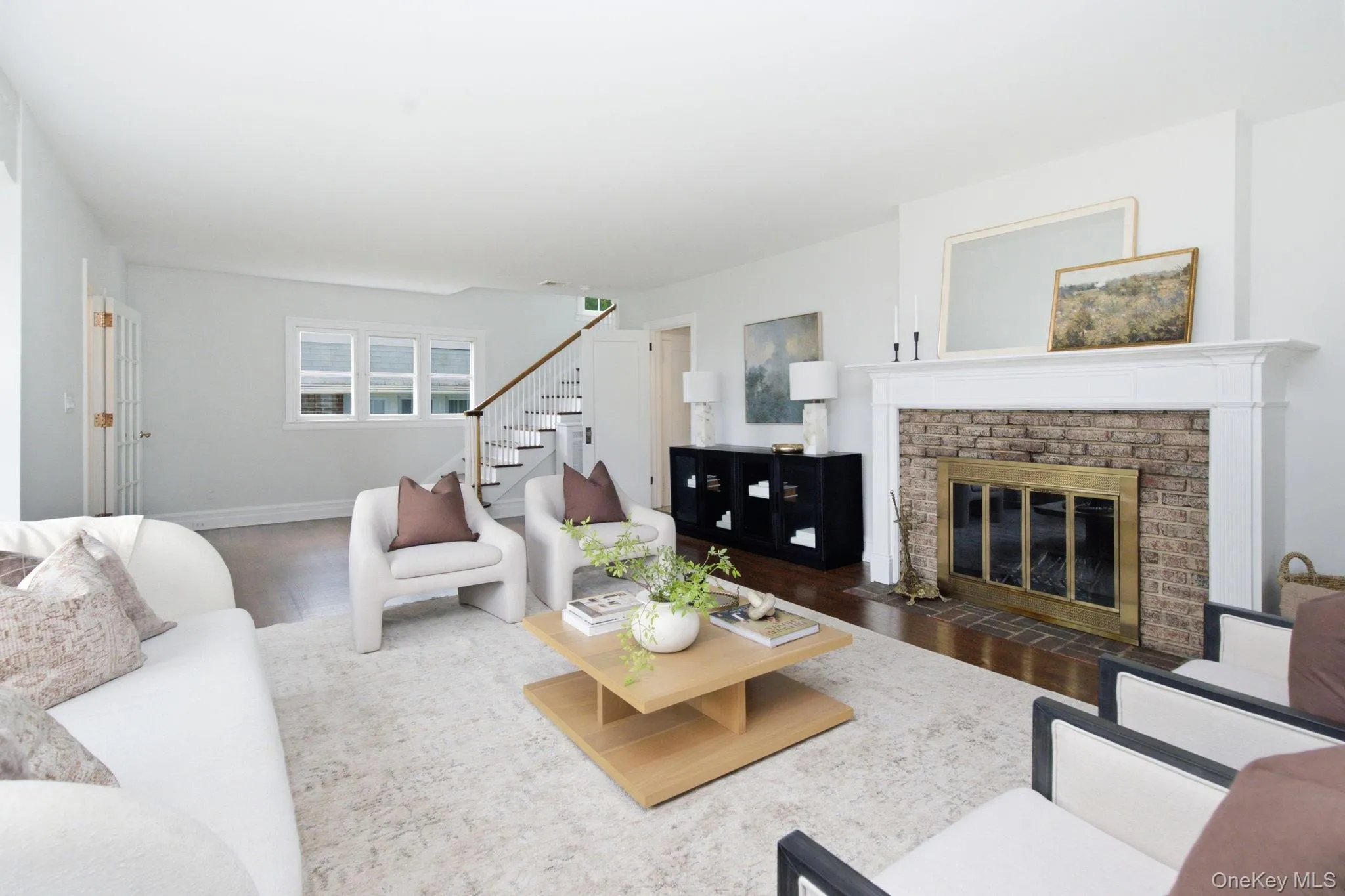 A brick surround and detailed white mantel create an inviting focal point. A brick surround and detailed white mantel create an inviting focal point.