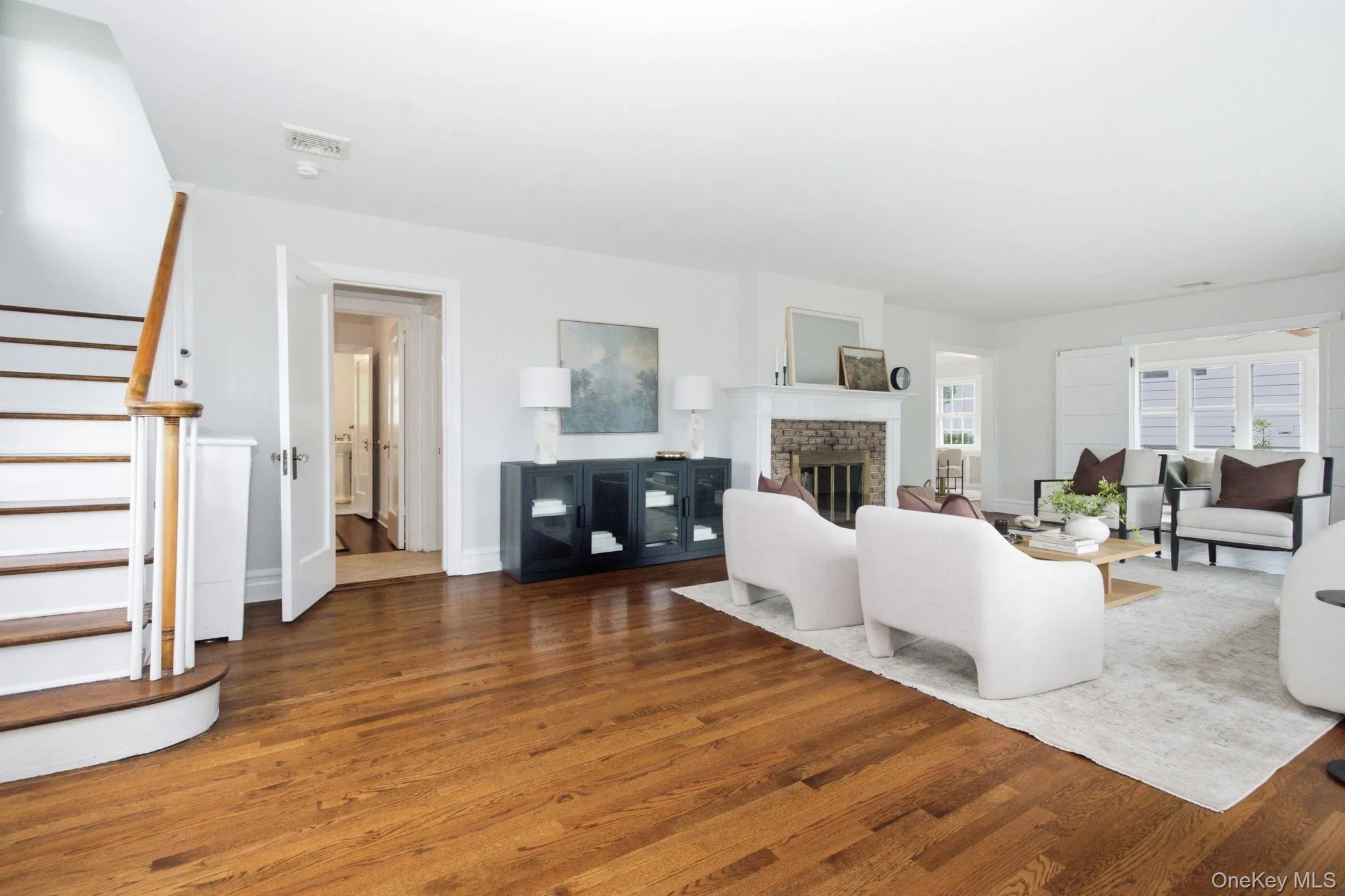 Gleaming wood floors flow from the turned staircase through the main level. Gleaming wood floors flow from the turned staircase through the main level.