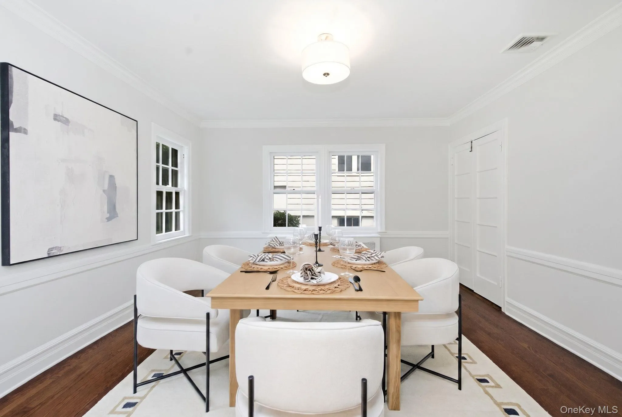 Crown molding and chair rail detail bring timeless character to the dining room. Crown molding and chair rail detail bring timeless character to the dining room.
