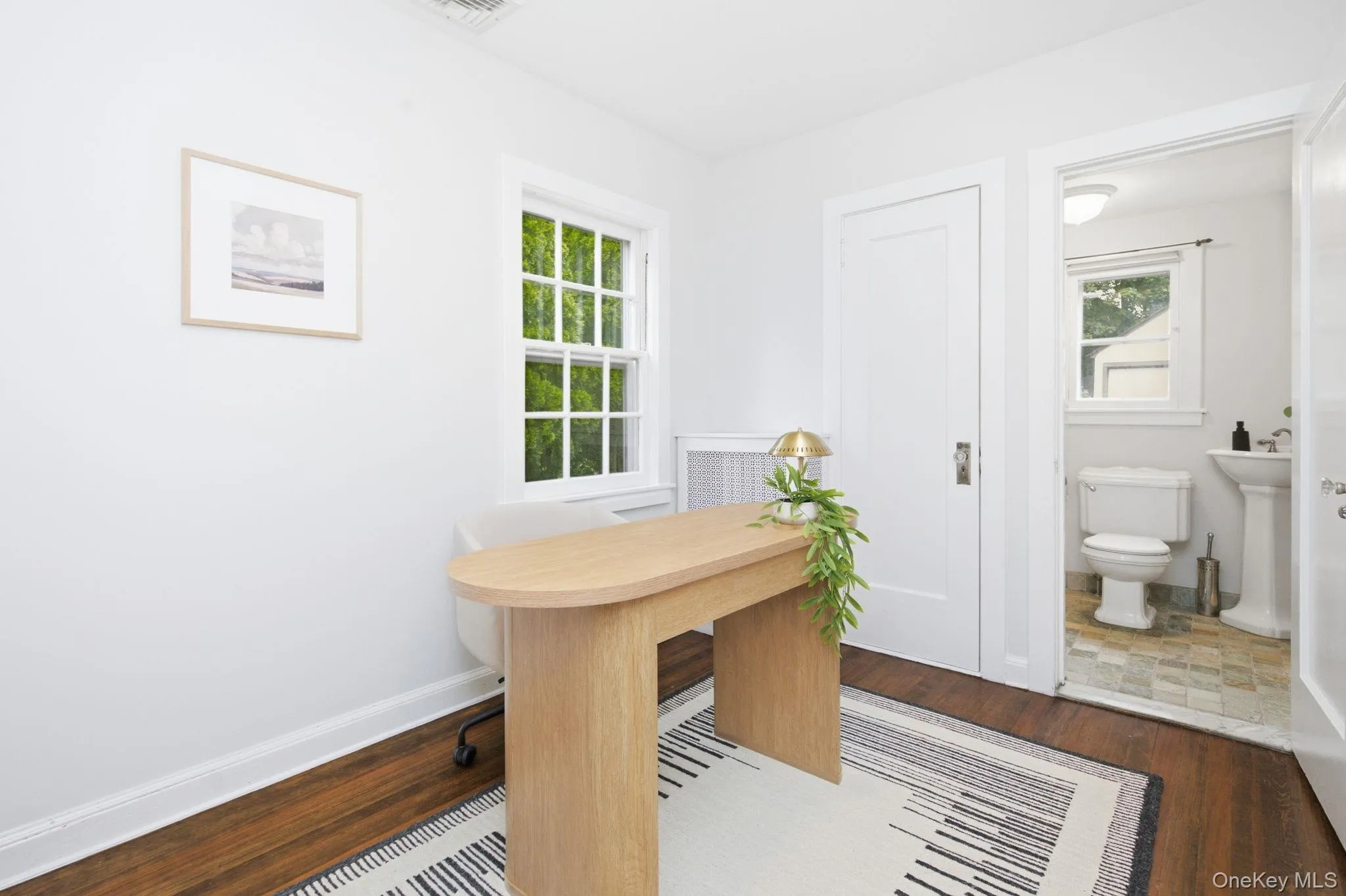 A first floor bedroom with its own half bath offers flexible use as a guest room or home office. A first floor bedroom with its own half bath offers flexible use as a guest room or home office.