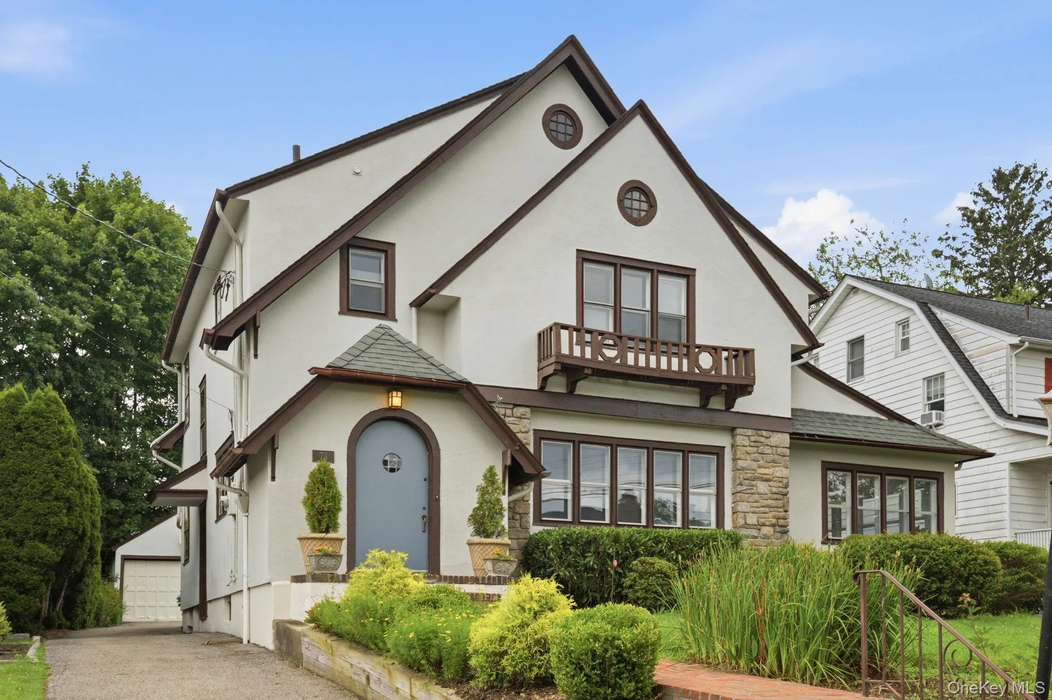 Stone accents and a decorative balcony highlight the home's distinctive architecture. Stone accents and a decorative balcony highlight the home's distinctive architecture.