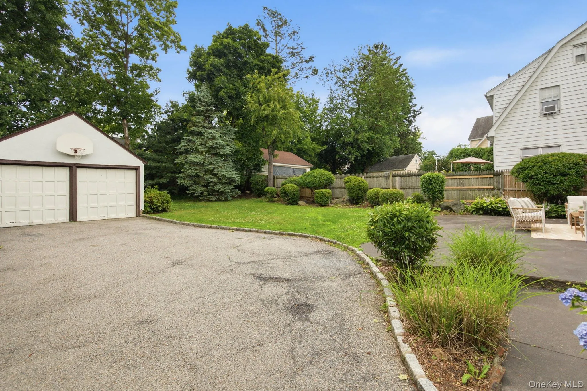 The detached two car garage adds covered parking, with a level lawn and fenced yard beyond. The detached two car garage adds covered parking, with a level lawn and fenced yard beyond.