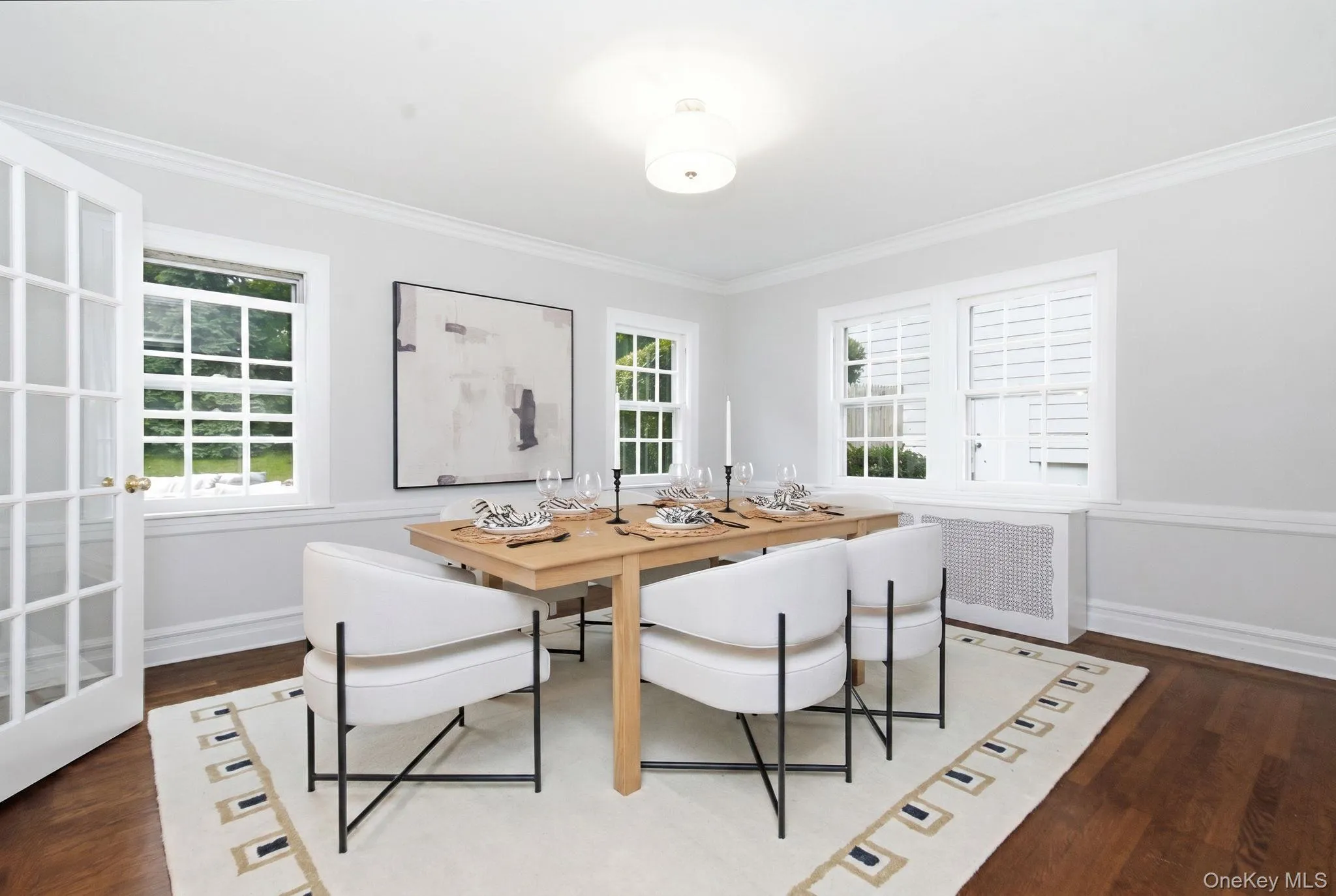 The spacious dining room offers hardwood floors and windows on two walls that keep it bright from morning to evening. The spacious dining room offers hardwood floors and windows on two walls that keep it bright from morning to evening.