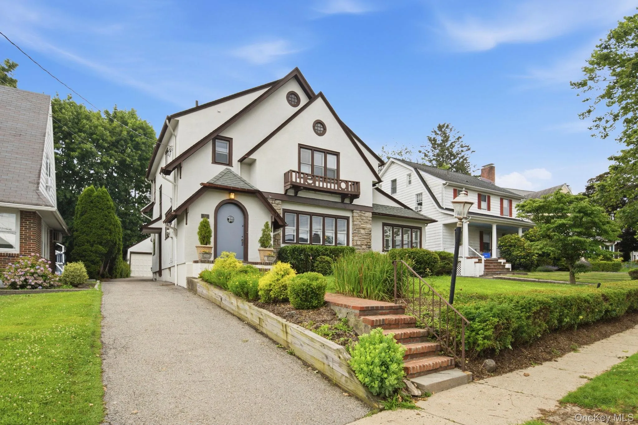 A long driveway offers ample off-street parking with terraced plantings along the approach. A long driveway offers ample off-street parking with terraced plantings along the approach.
