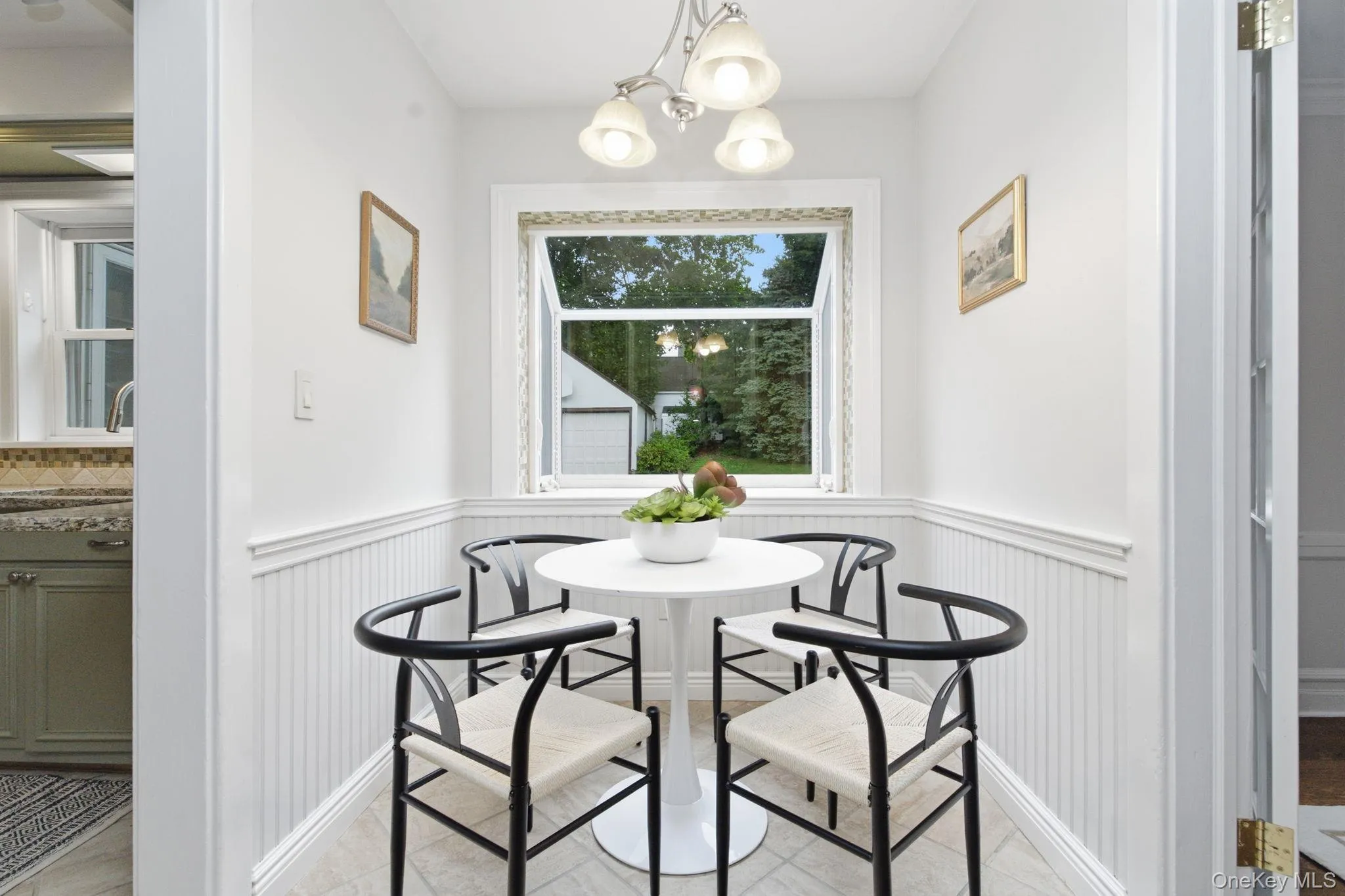 Beadboard wainscoting wraps the breakfast nook in classic cottage charm. Beadboard wainscoting wraps the breakfast nook in classic cottage charm.