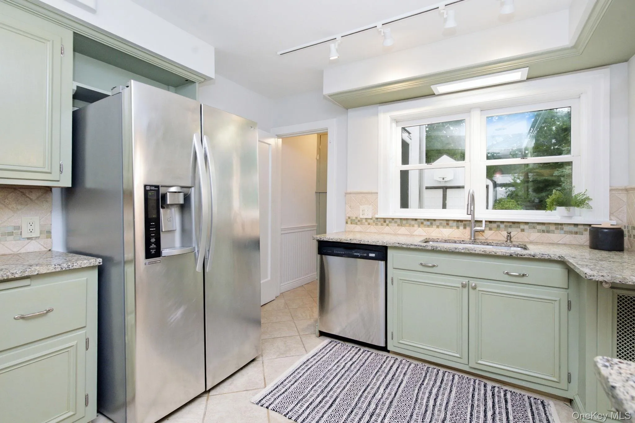 A sunny window over the sink brightens daily kitchen routines. A sunny window over the sink brightens daily kitchen routines.