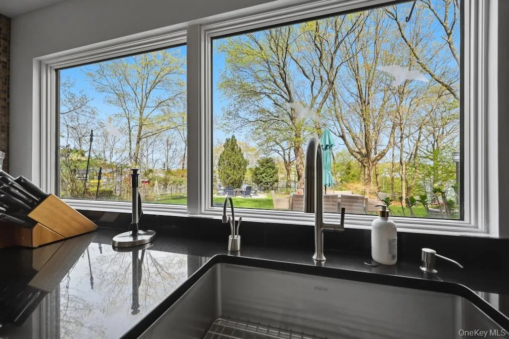 Kitchen window overlooking a landscaped exterior Kitchen window overlooking a landscaped exterior