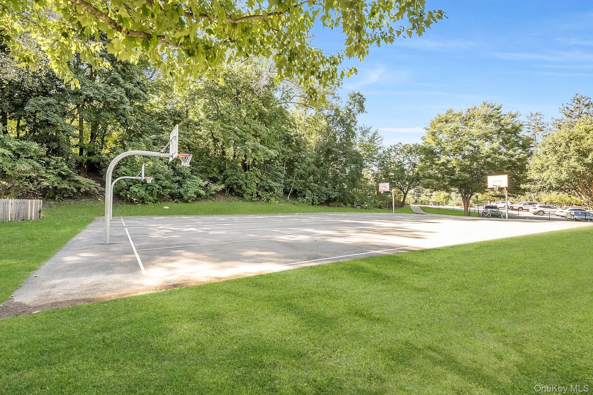 View of basketball court with a yard and community basketball court View of basketball court with a yard and community basketball court