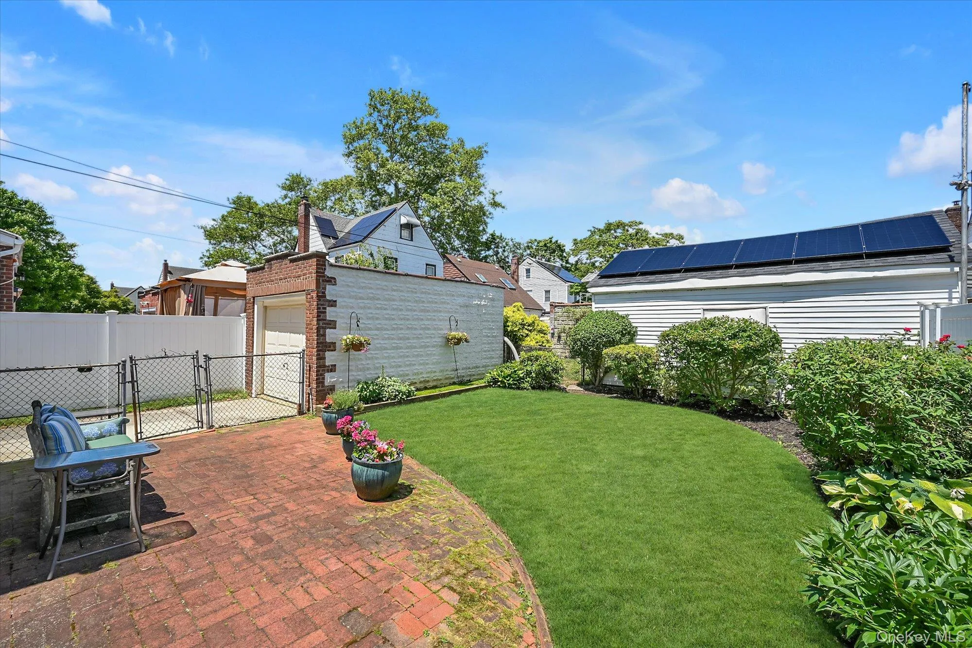 Backyard With Patio, Gardens and One Car Garage. Backyard With Patio, Gardens and One Car Garage.