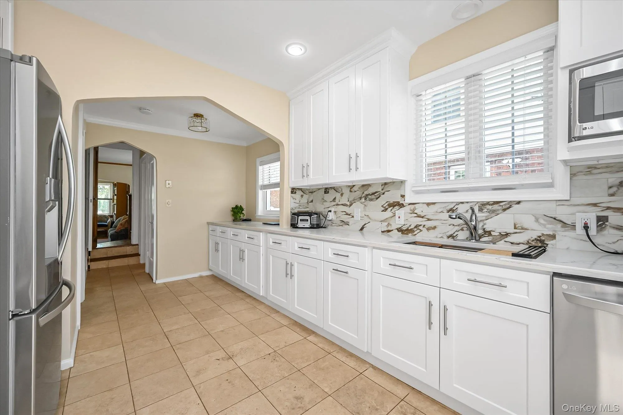Newly Renovated Kitchen With Quartz Countertops and Travertine Tile Floors Newly Renovated Kitchen With Quartz Countertops and Travertine Tile Floors