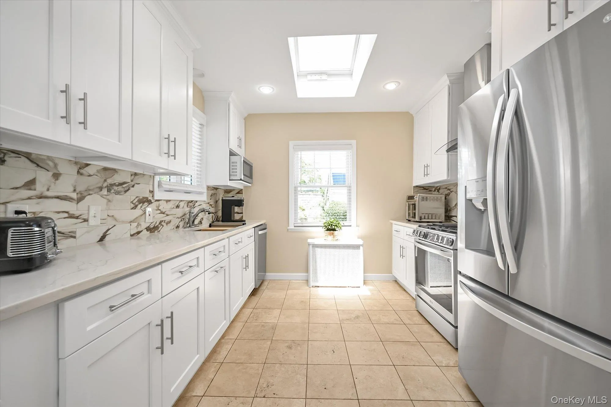 Newly Renovated Kitchen With Quartz Countertops and Travertine Tile Floors Newly Renovated Kitchen With Quartz Countertops and Travertine Tile Floors