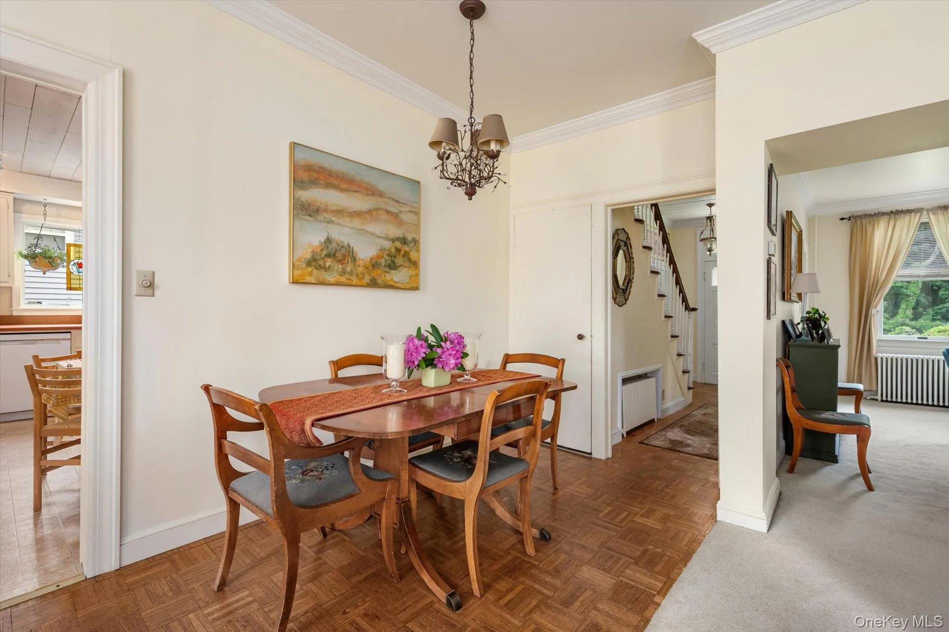 Dining area featuring wood-finish parquet flooring and crown molding Dining area featuring wood-finish parquet flooring and crown molding
