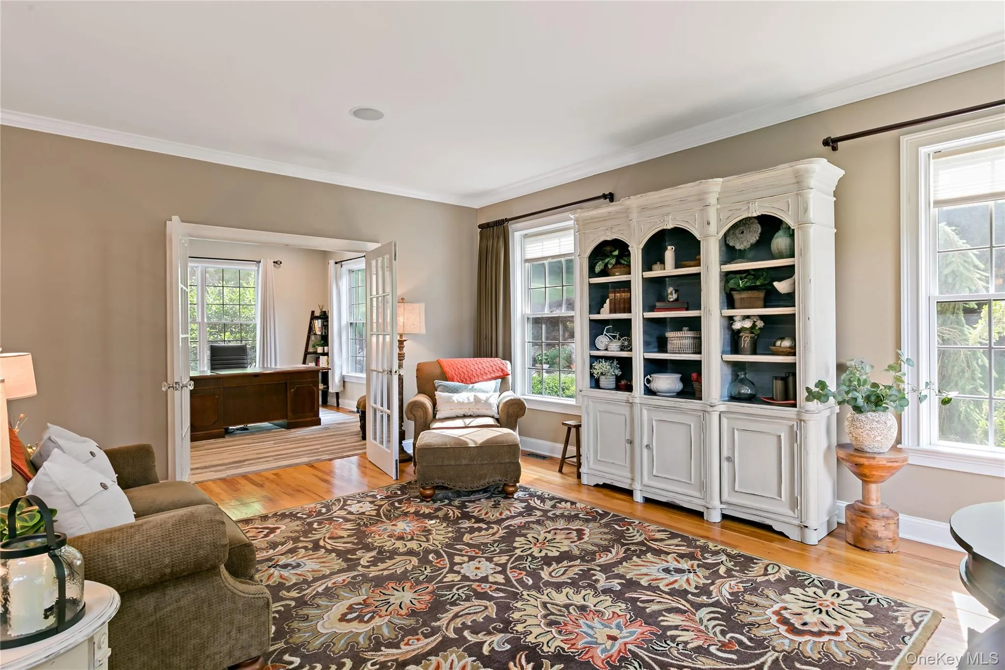Formal living room with custom built ins and high ceilings showing doorway into study. Formal living room with custom built ins and high ceilings showing doorway into study.