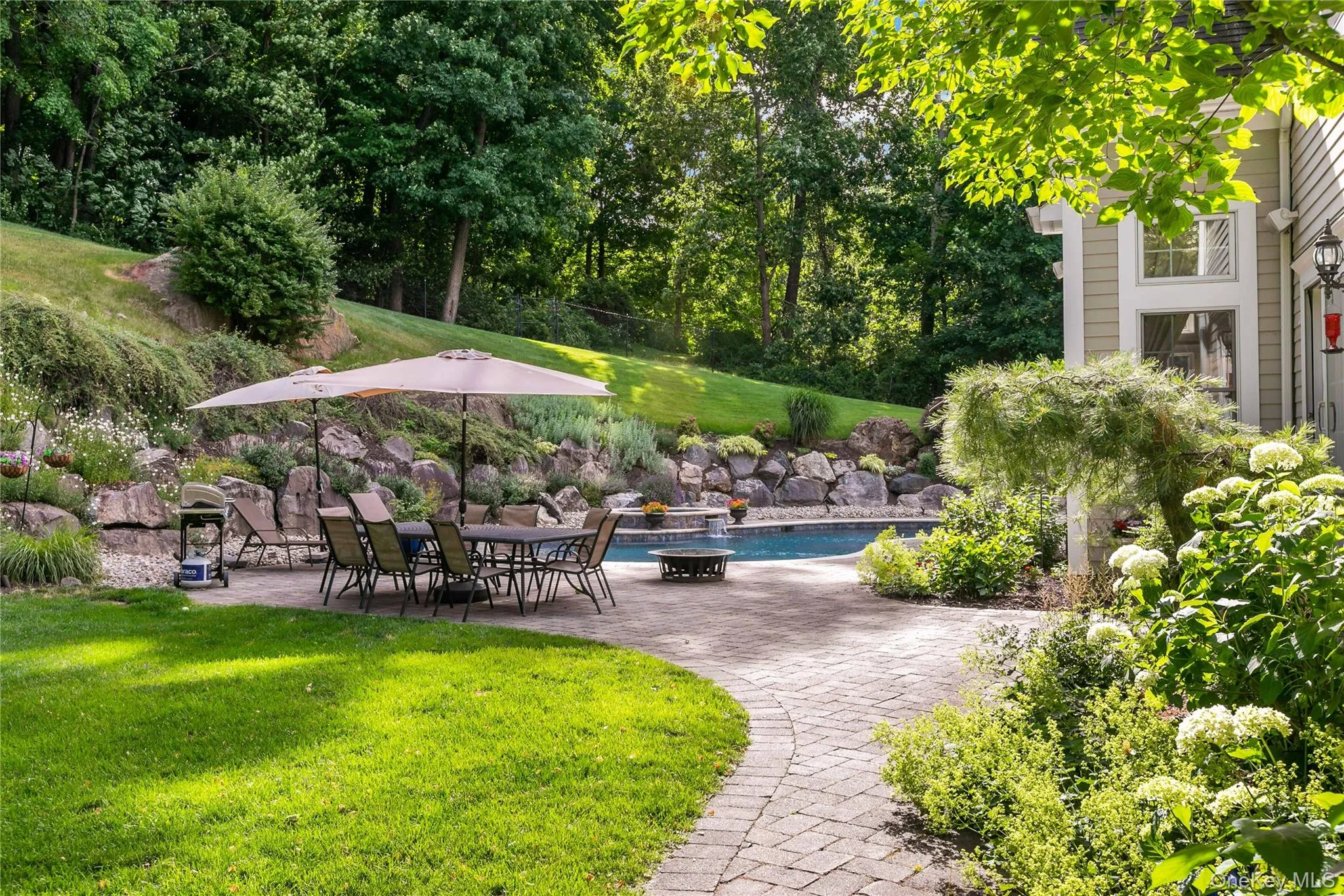 Lush gardens with perennial plantings and specimen trees. Lush gardens with perennial plantings and specimen trees.