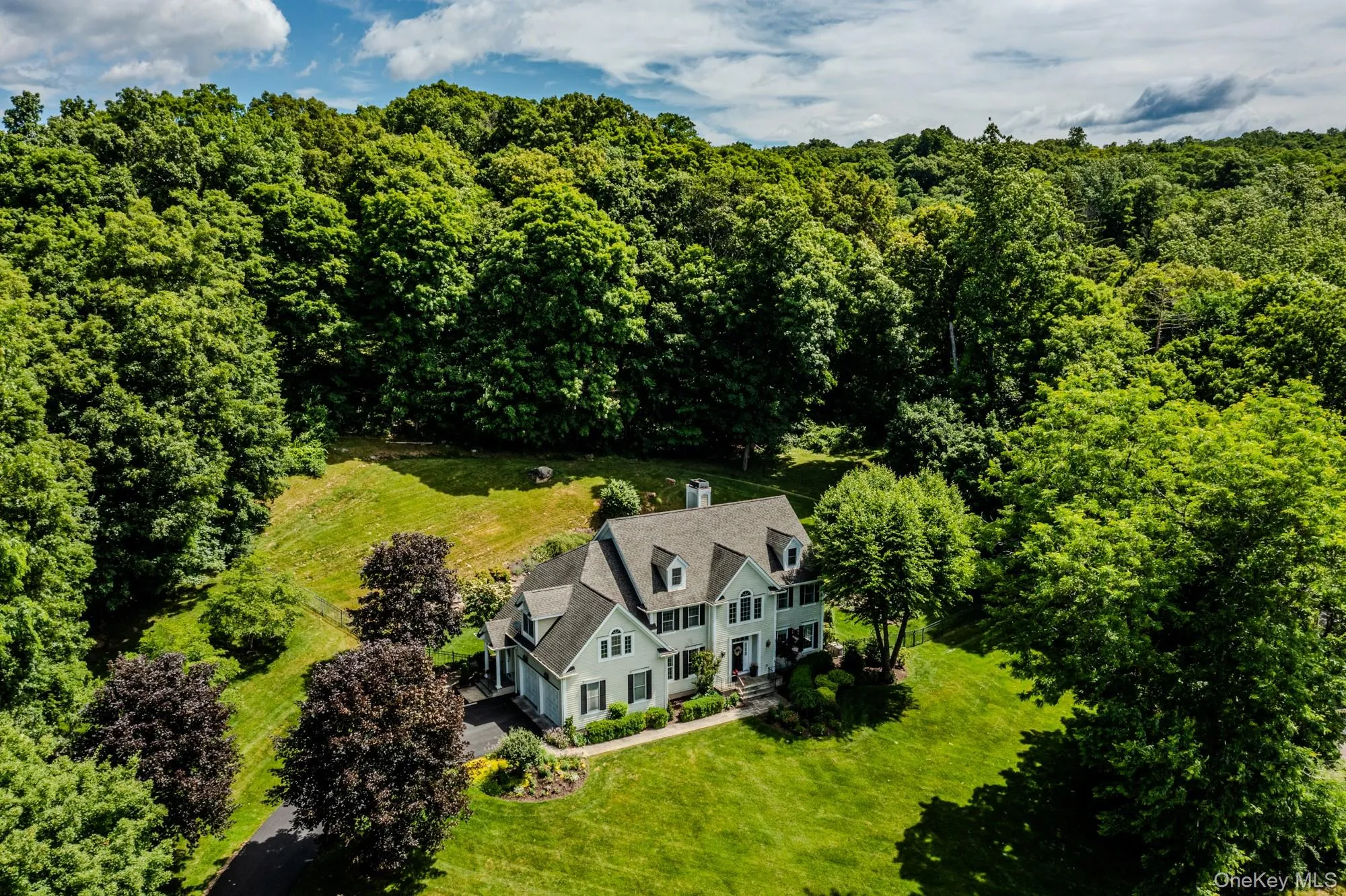 Front photo showing extensive lawns. Front photo showing extensive lawns.