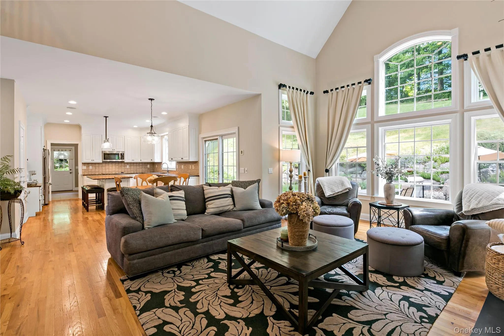 Enormous great room showing living area, eat in kitchen area, kitchen and door to mud room in background. Enormous great room showing living area, eat in kitchen area, kitchen and door to mud room in background.