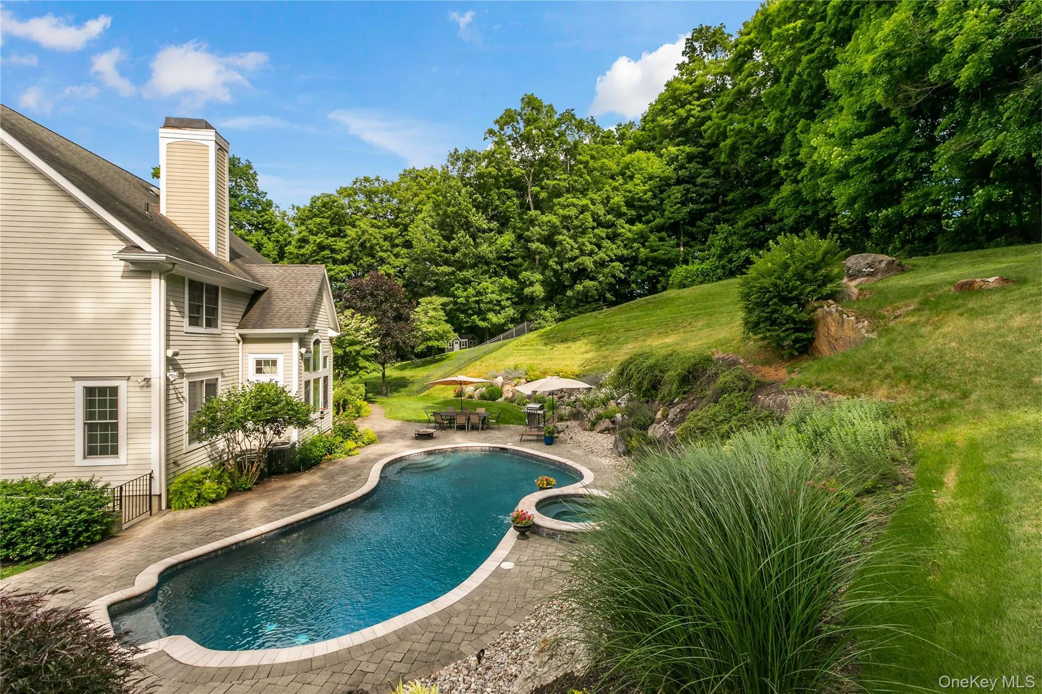 Salt water pool showing built in hot tub. Salt water pool showing built in hot tub.