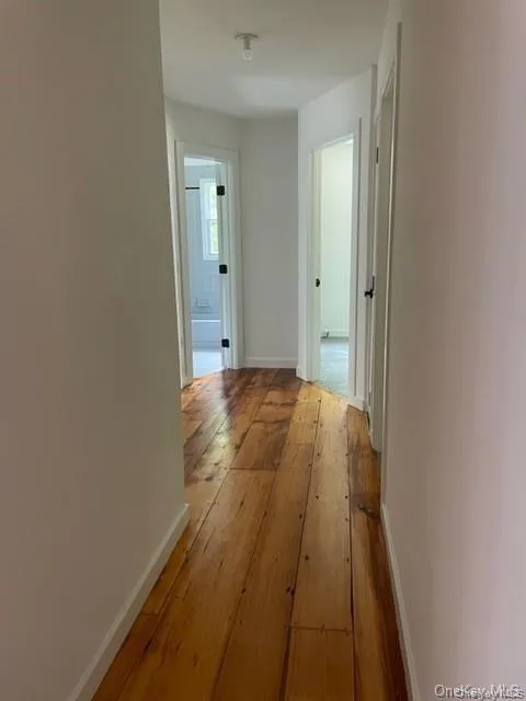 Hall featuring hardwood / wood-style flooring Hall featuring hardwood / wood-style flooring