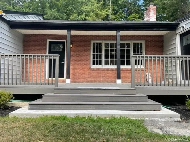 Property entrance featuring covered porch Property entrance featuring covered porch